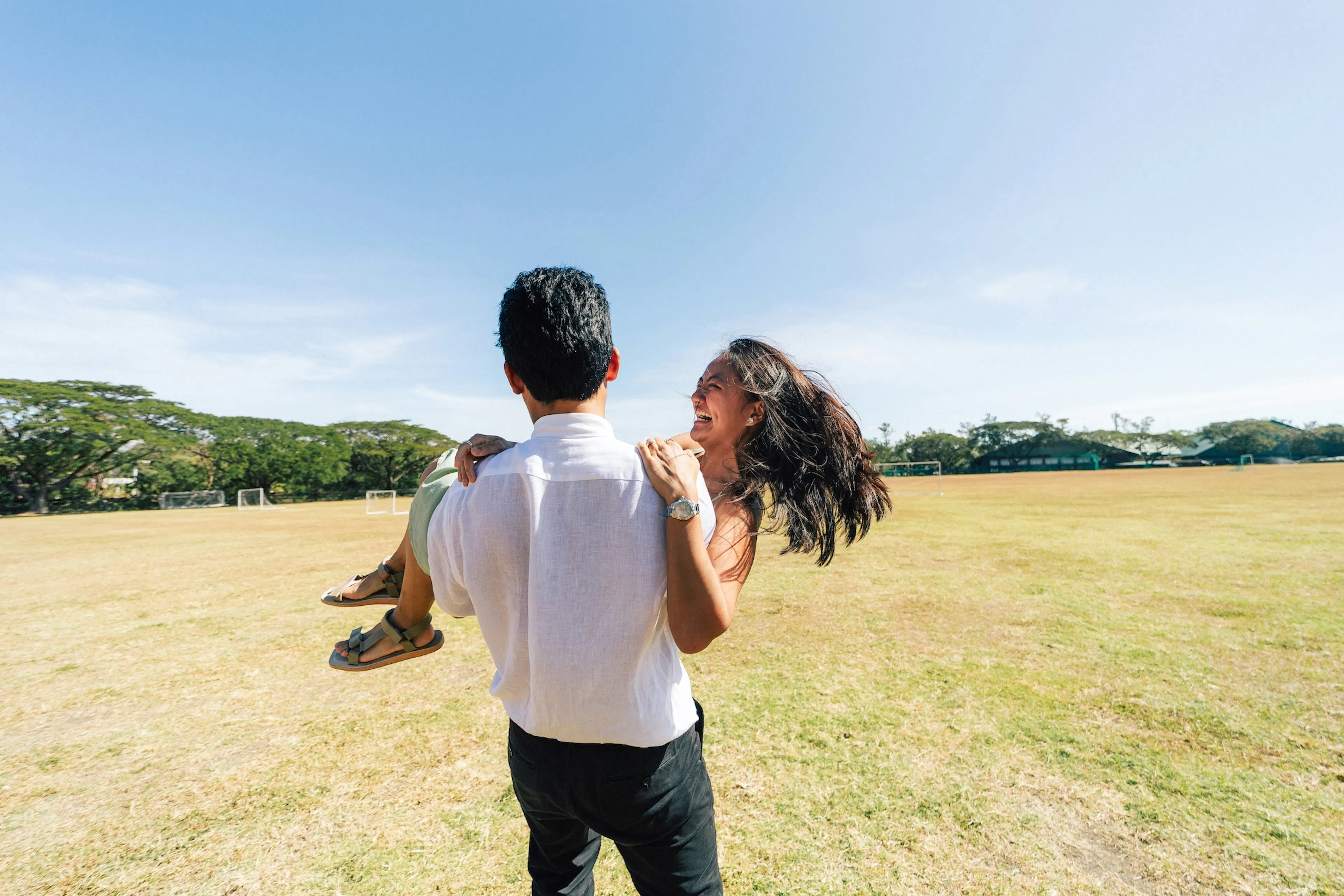 couple spinning in the grass