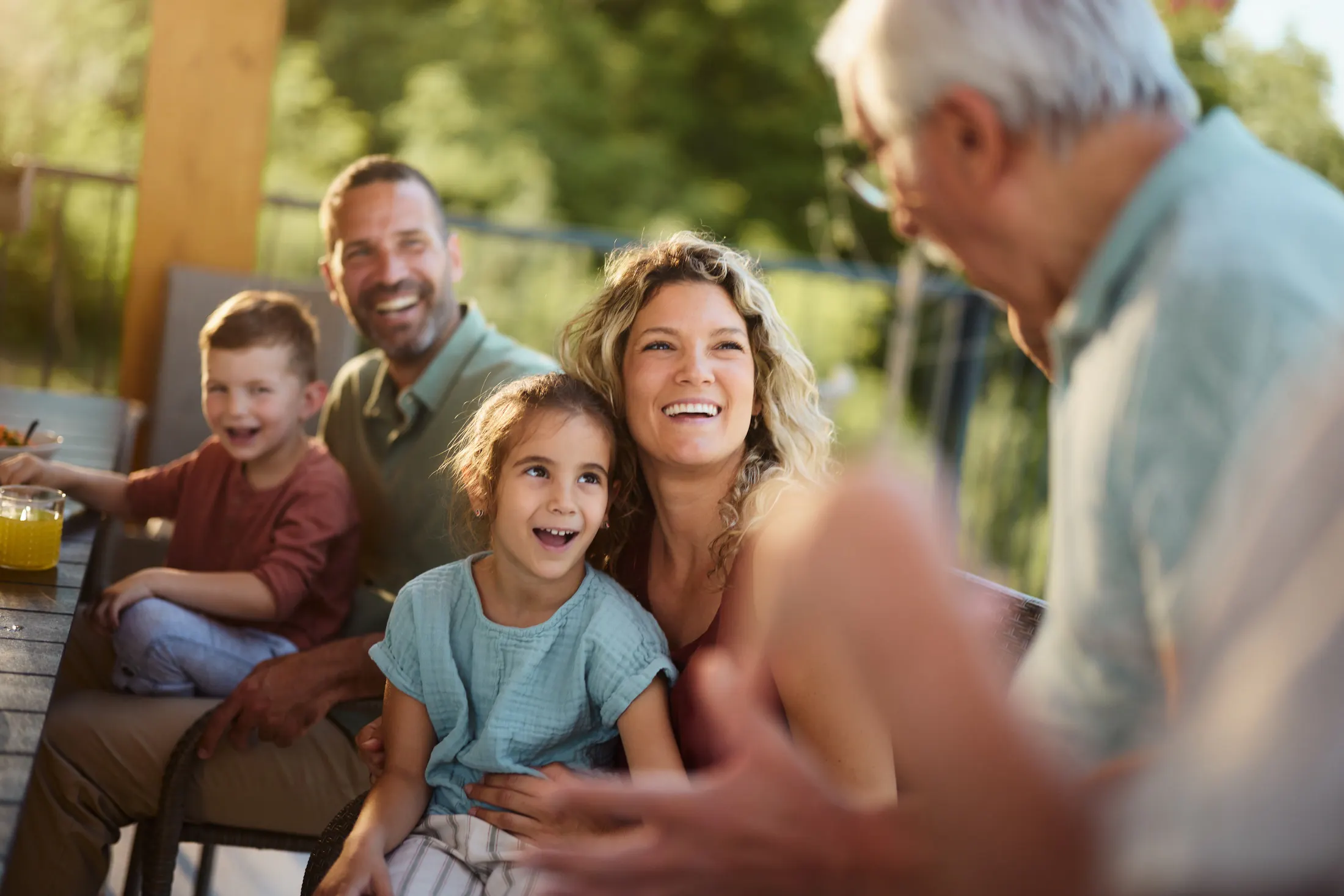 Happy family talking to grandfather
