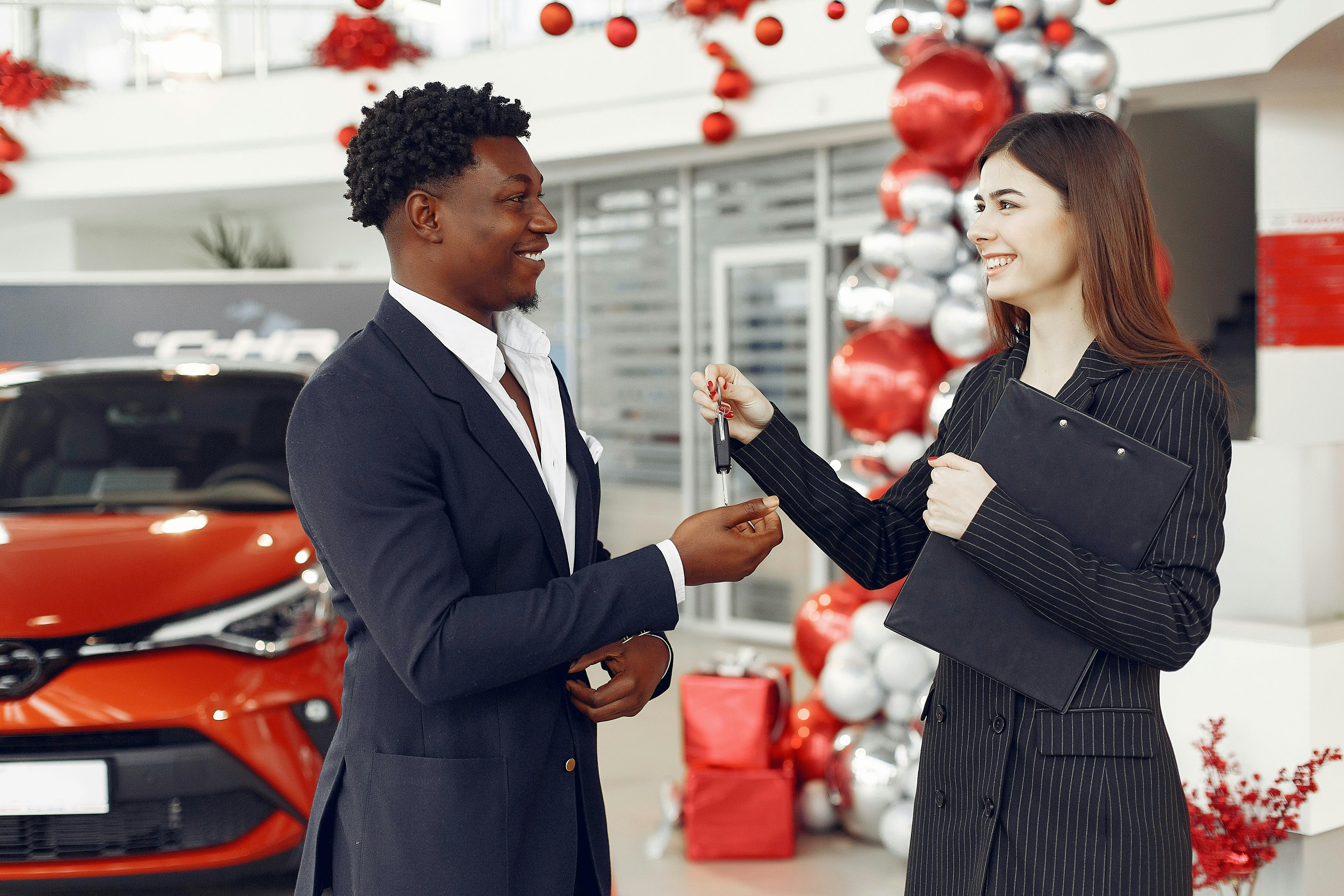 Man purchasing car getting keys