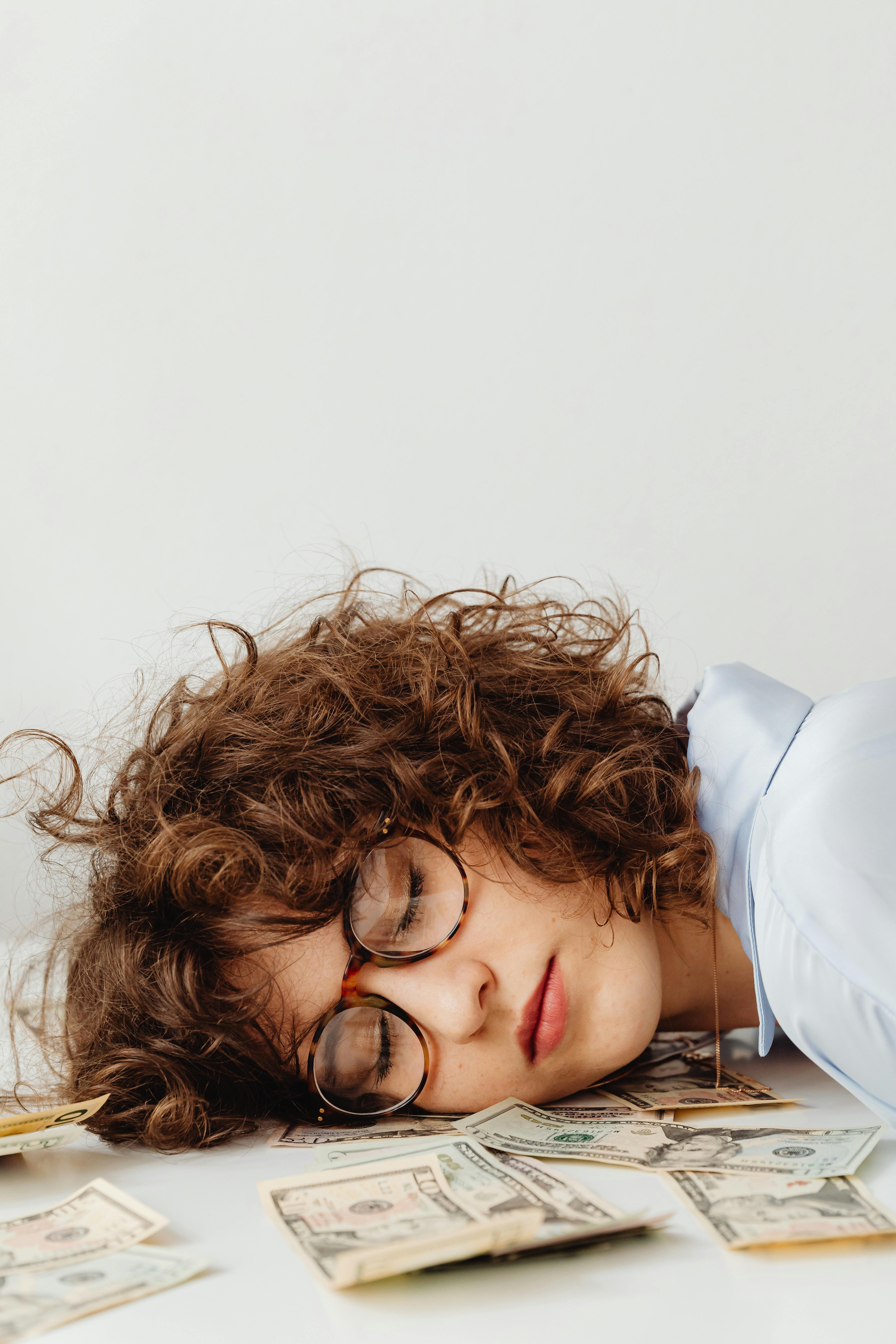 Woman Sleeping on Money