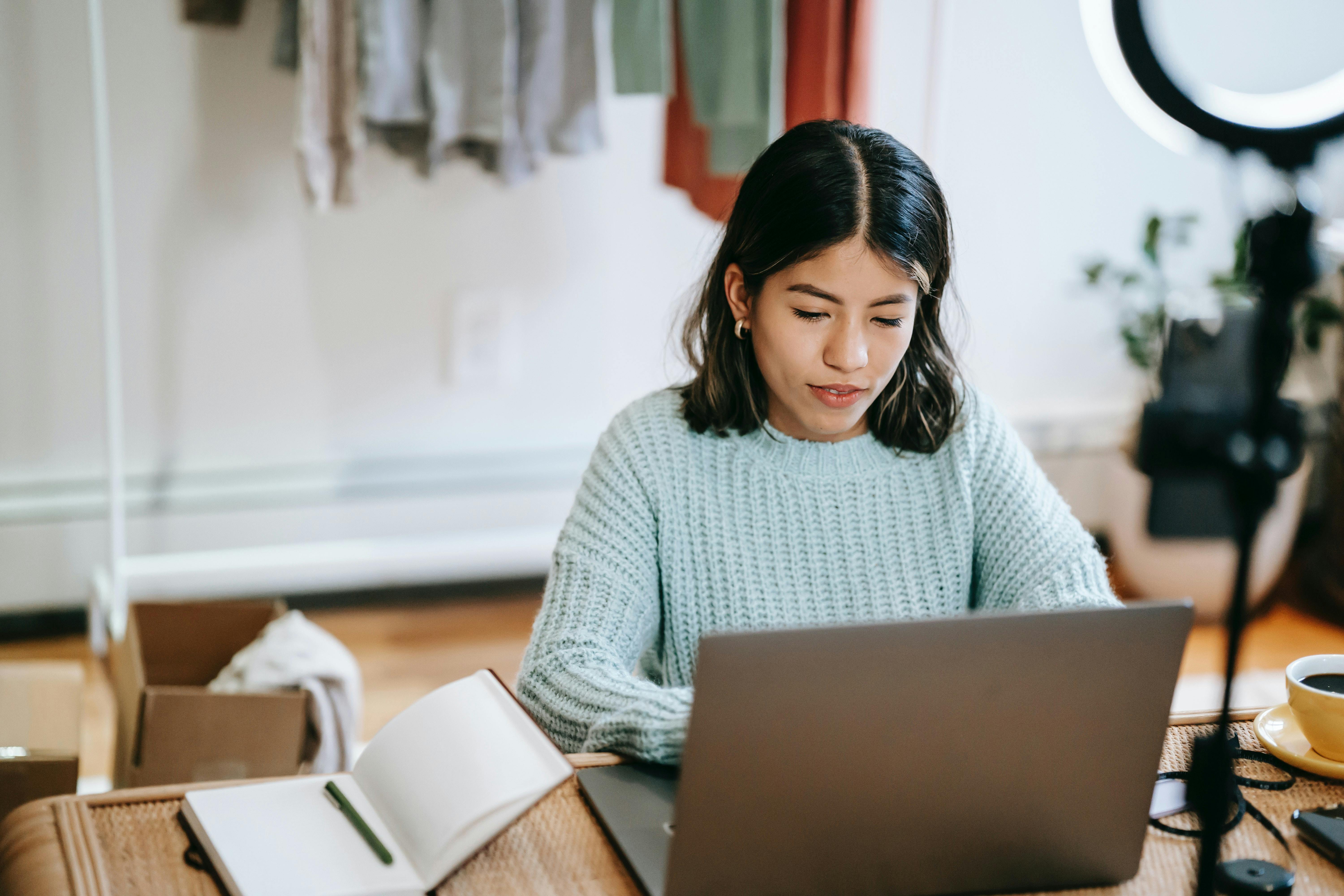 Woman entrepreneur in studio with laptop