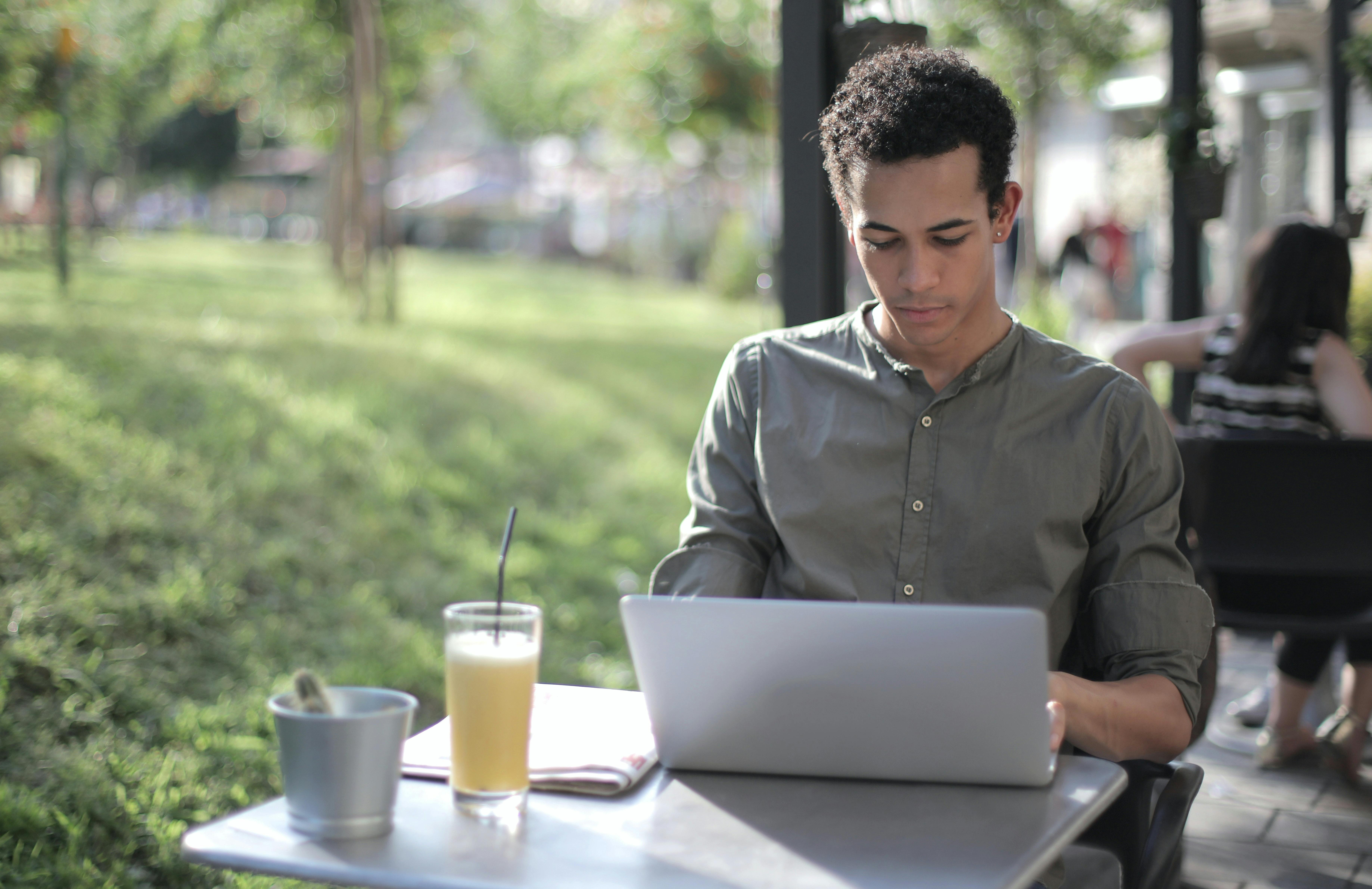 Man using laptop at cafe