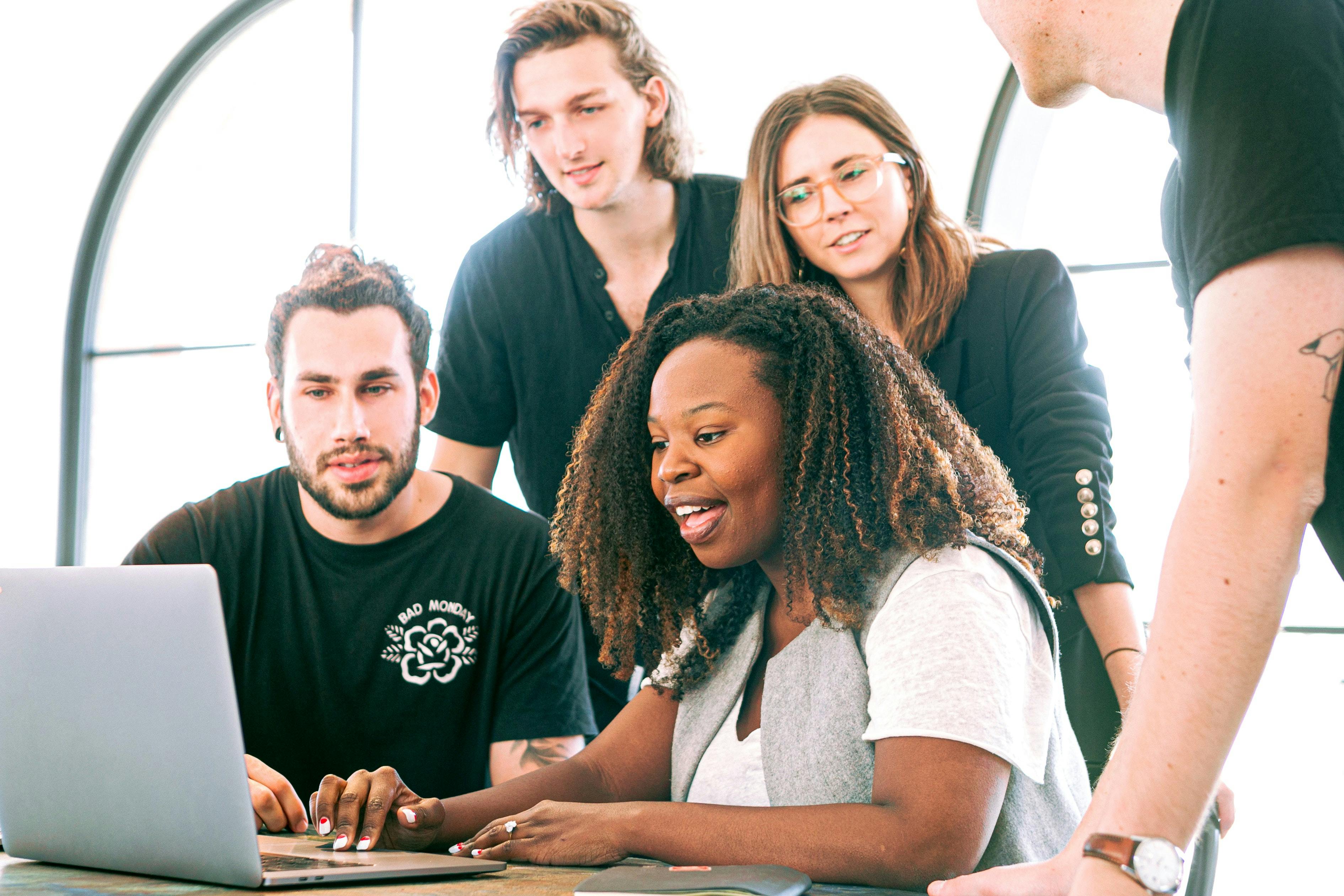 Woman and team using laptop at office