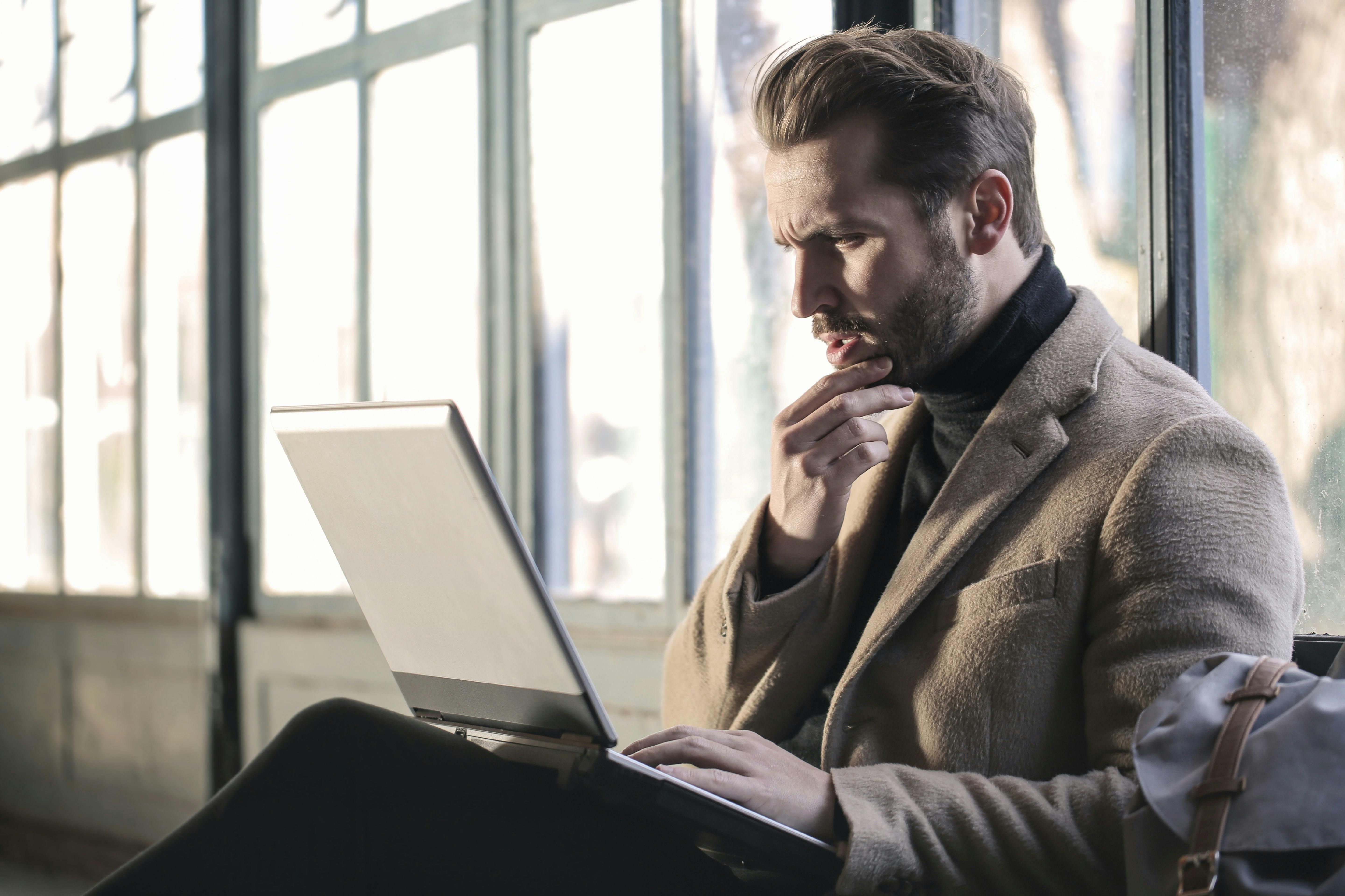 Skeptical man with laptop