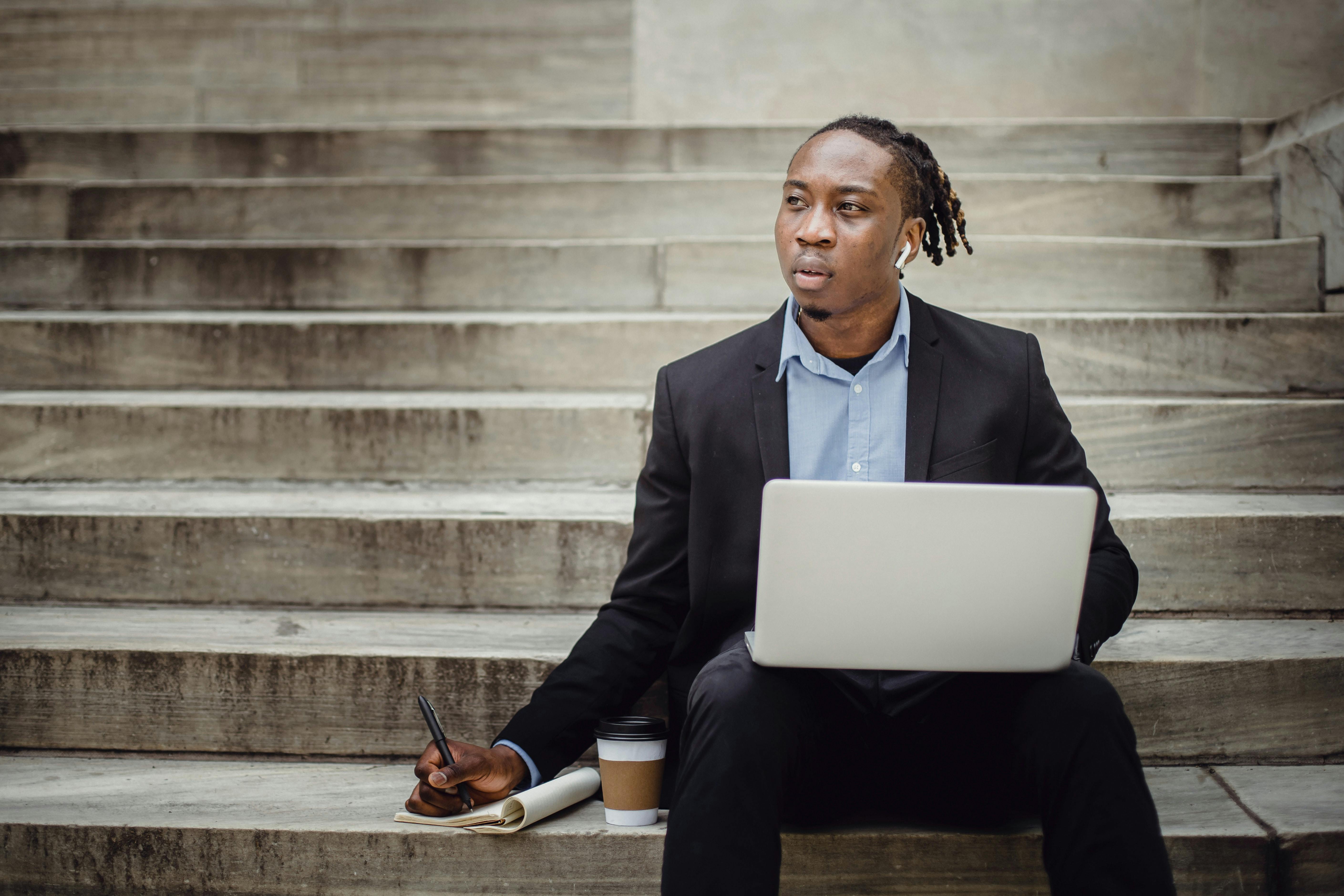 Entrepreneur with headphones taking notes