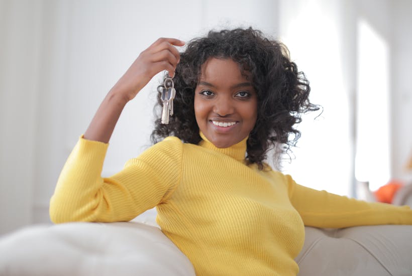 Woman on couch holding house keys