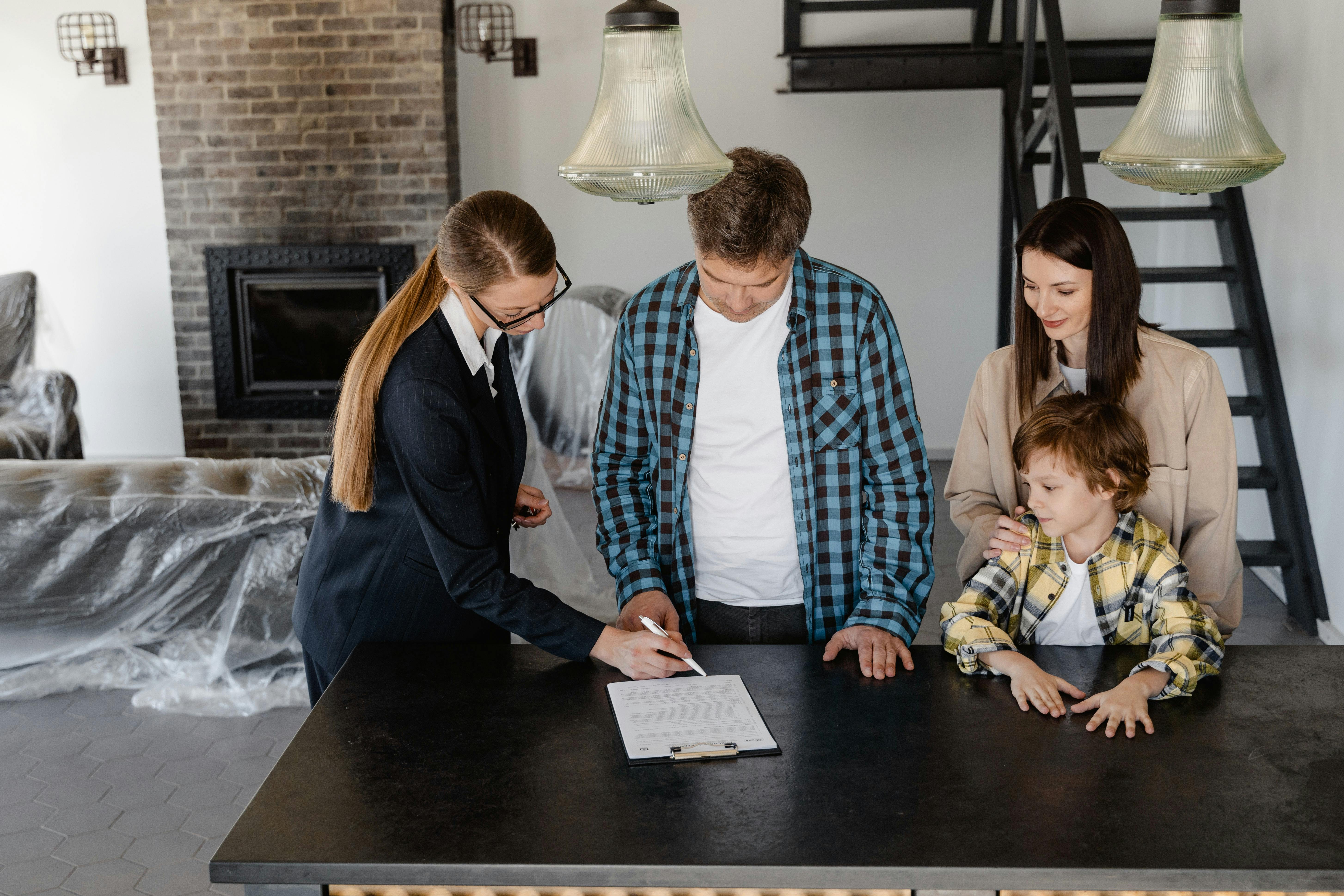 Real estate agent reviewing documents with family