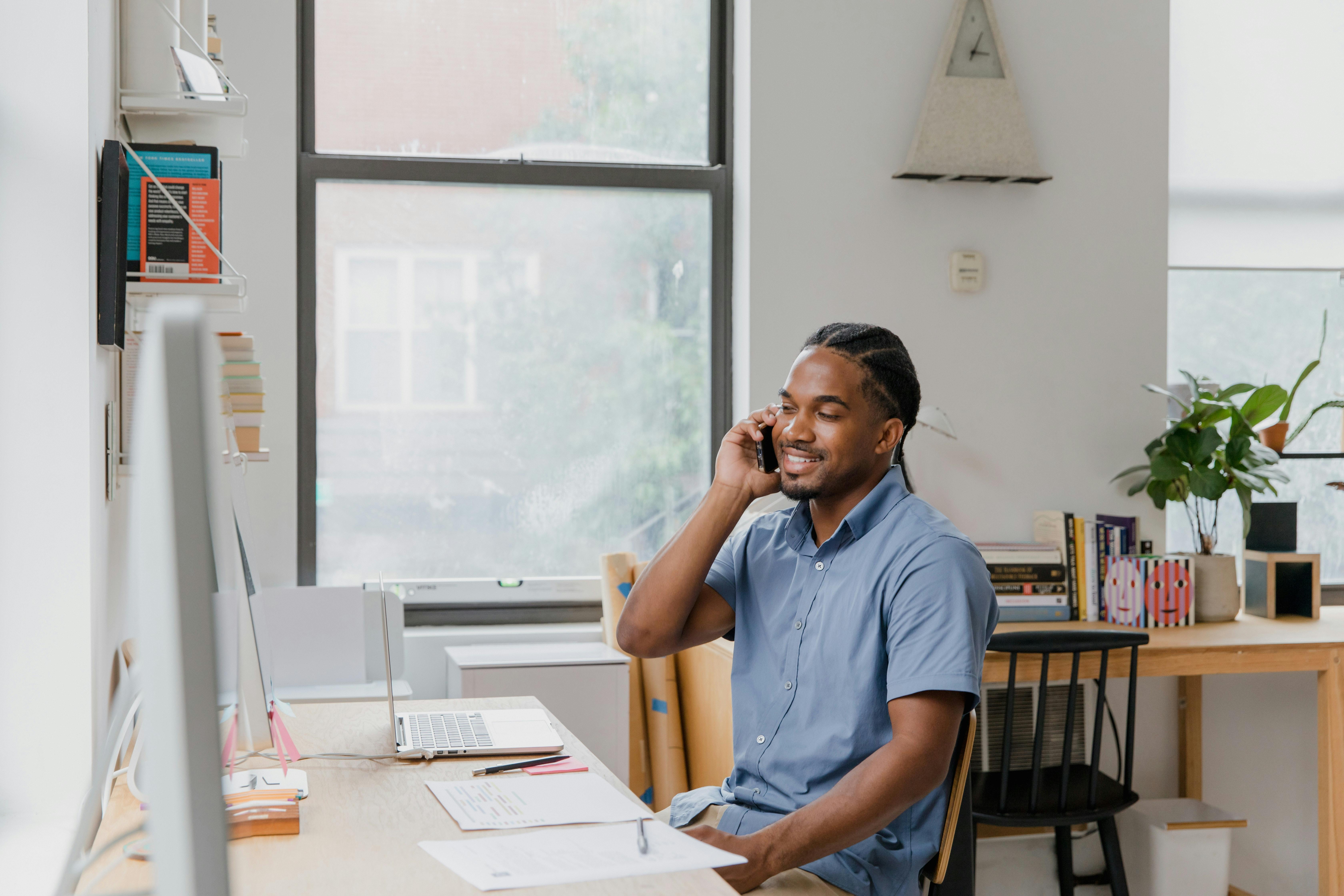 Business owner at desk talking on phone