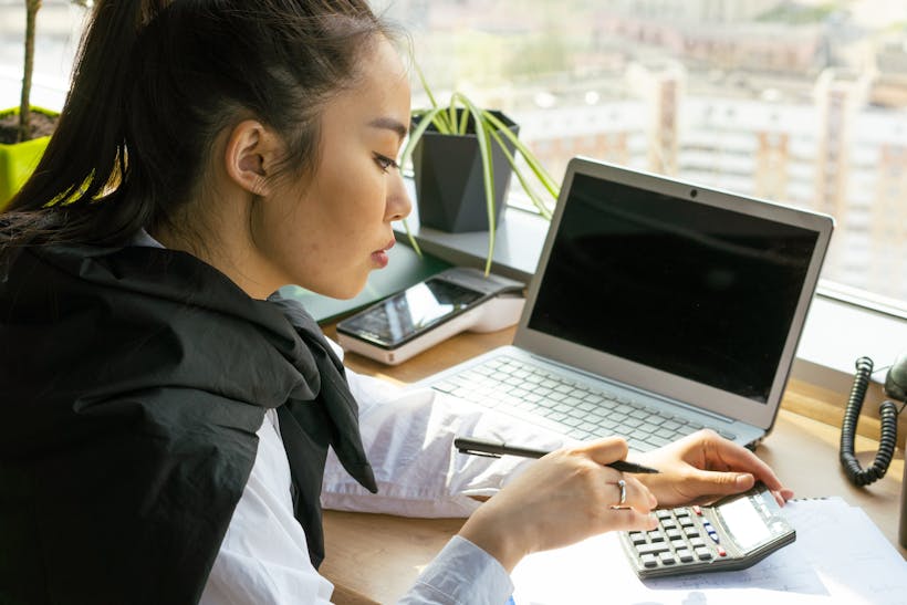 Woman at desk with calculator