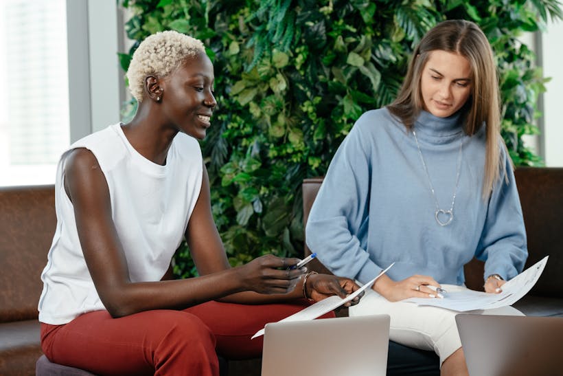 Women business partners reviewing documents