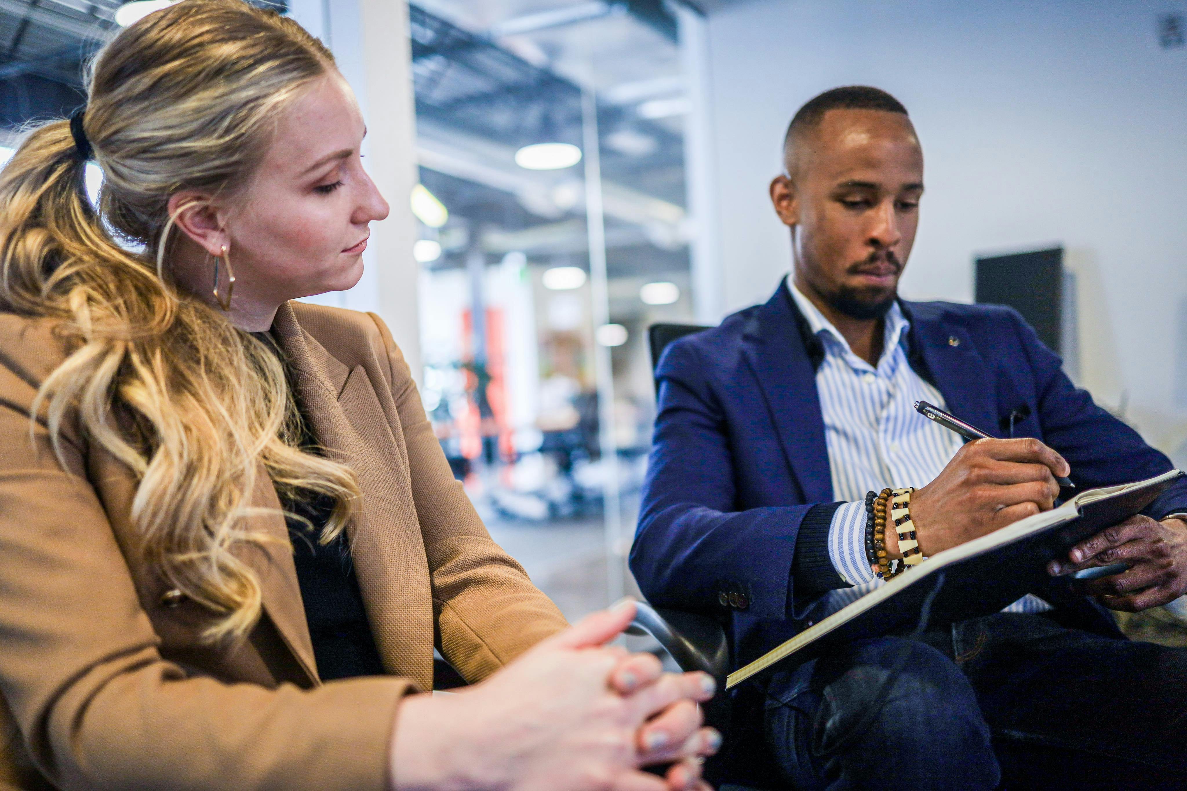 Man explaining to woman through writing