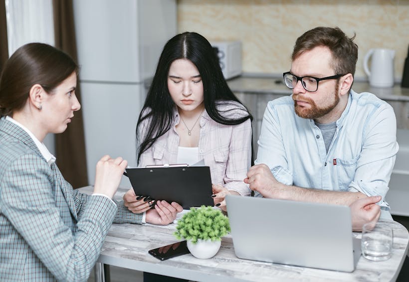 Couple sitting at table with financial advisor