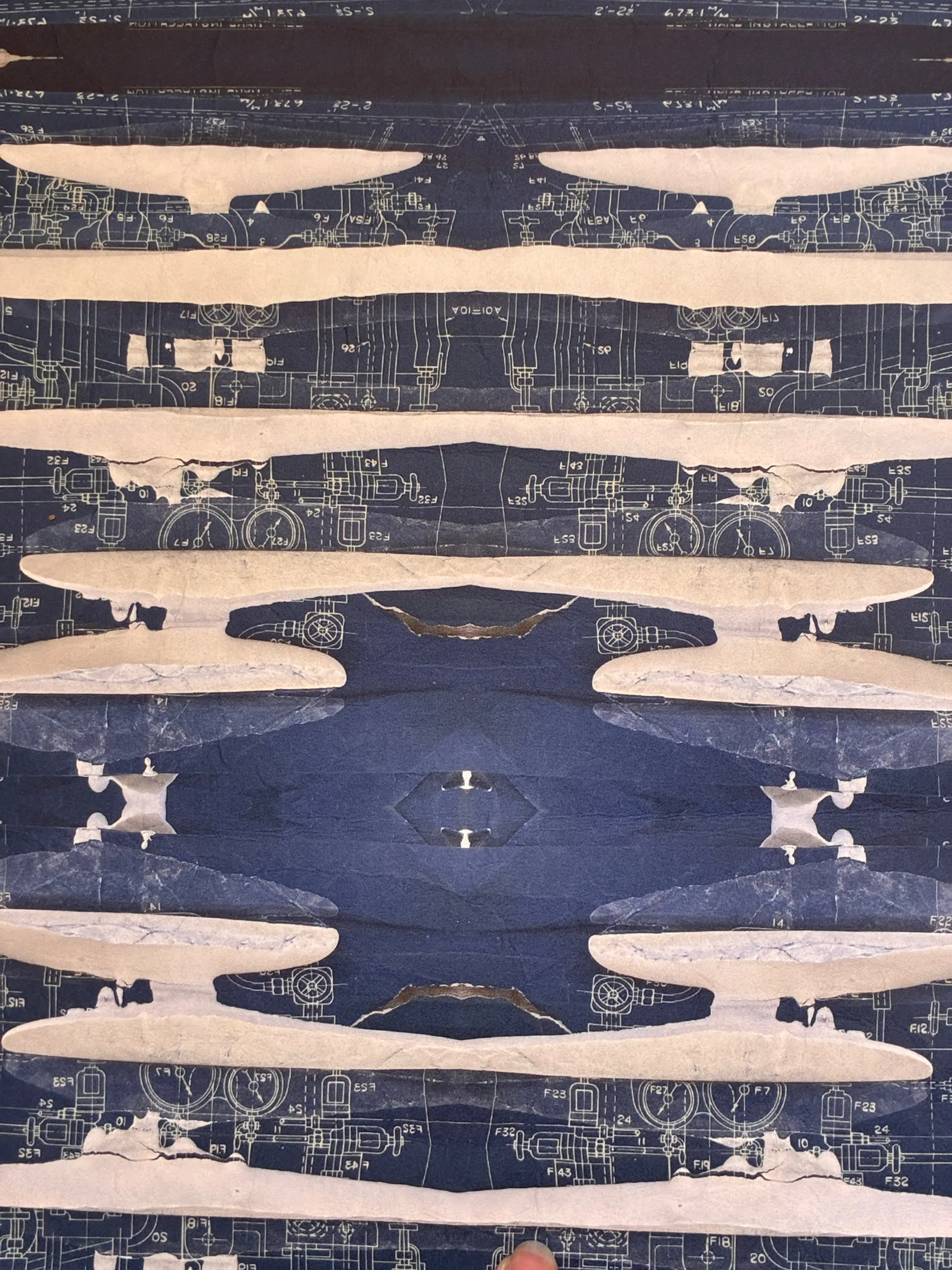 Mirrored blueprint print banded with pale plaster forms