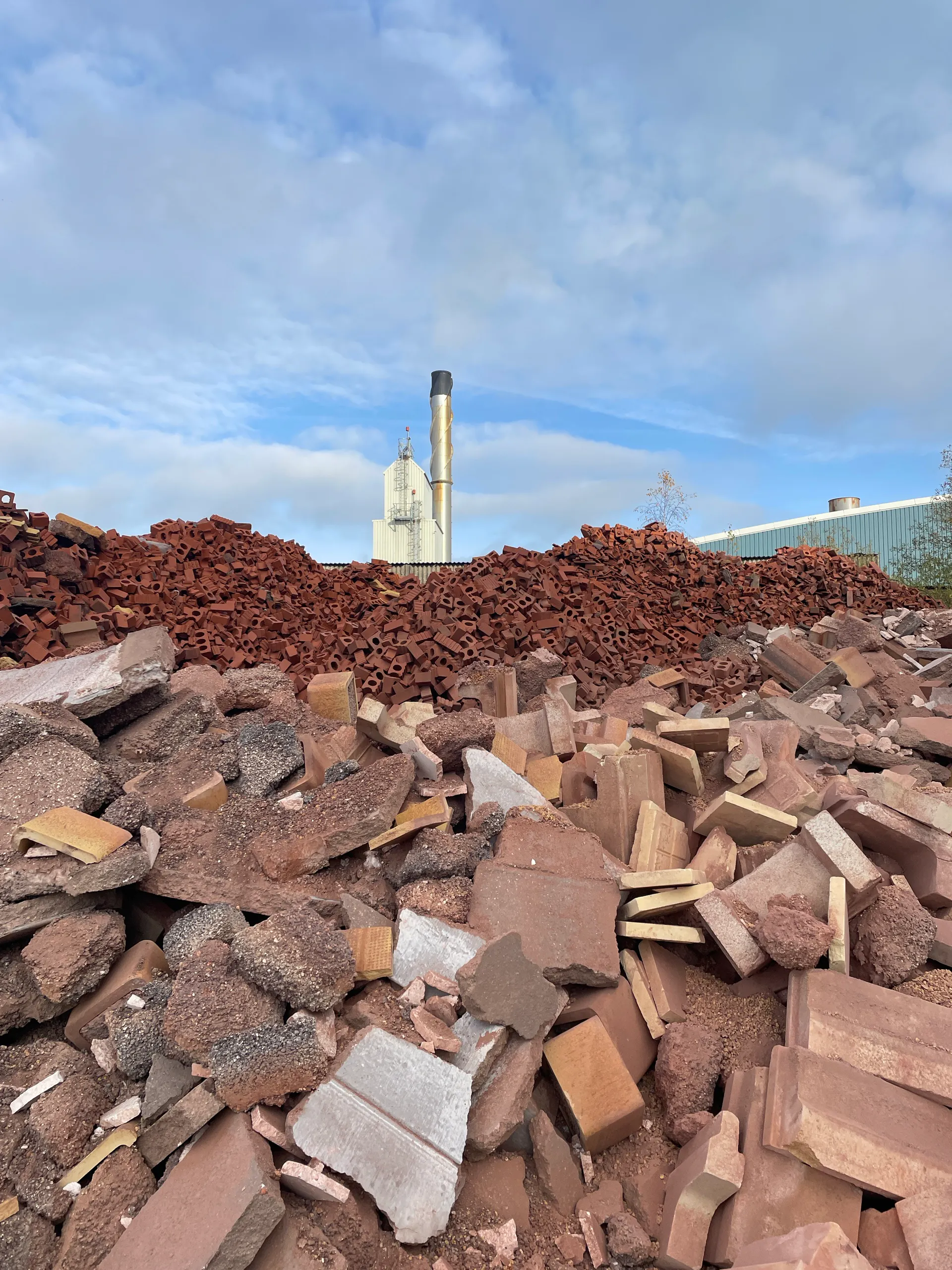 Spoil heaps of discarded brick at the works, kiln stack beyond