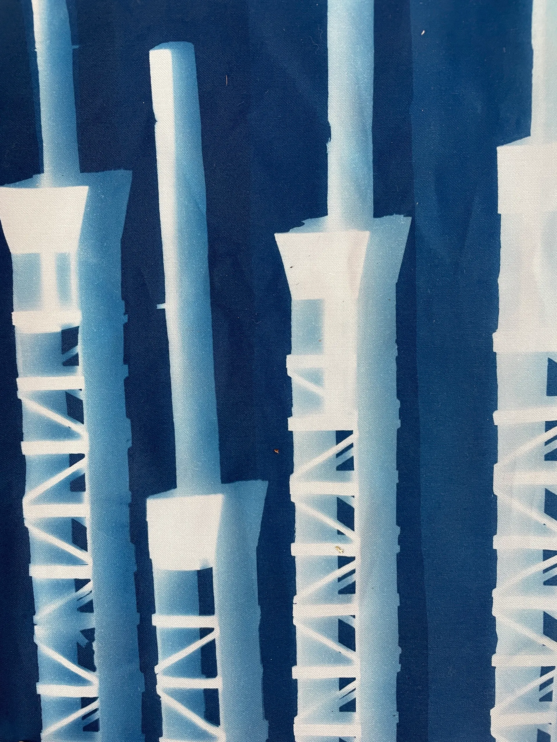 Tall tower forms exposed on deep blue linen
