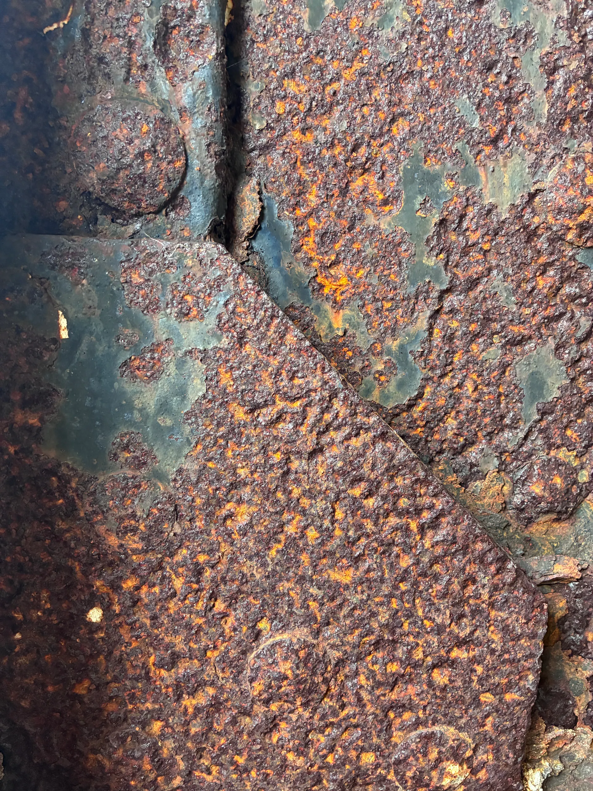 Deep corrosion across a cracked iron plate