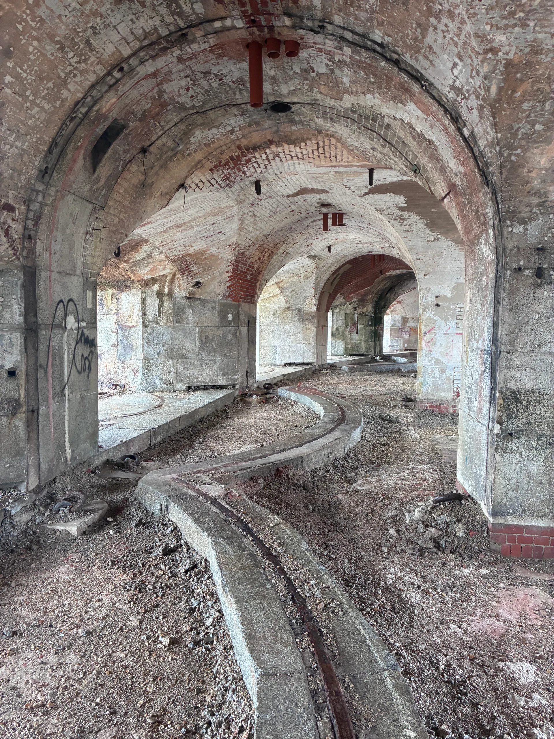 Curved iron rails set into a vaulted casemate floor