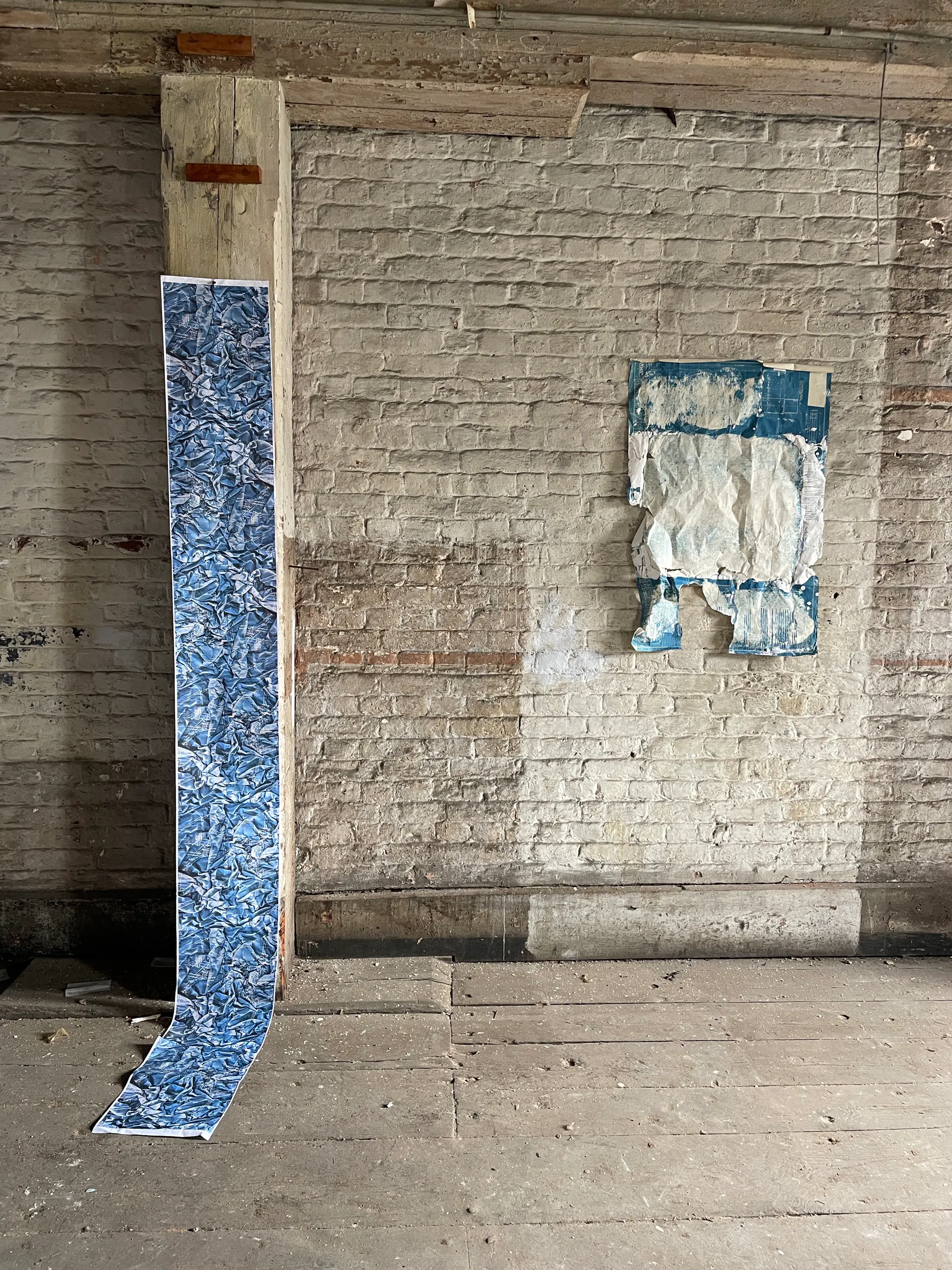 A hanging cyanotype scroll installed in the storehouse