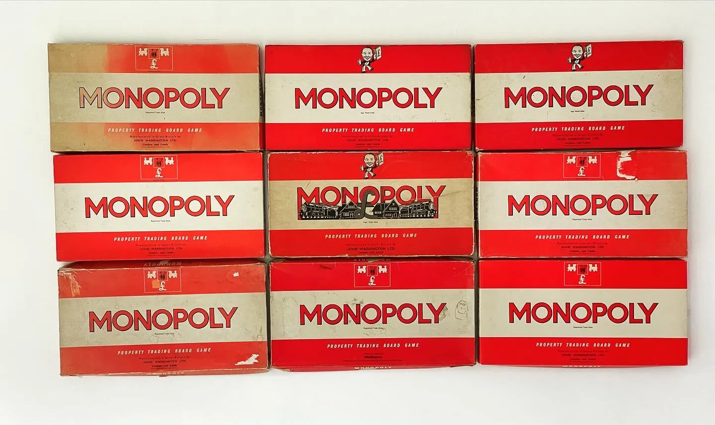 Nine vintage Monopoly sets in their red boxes