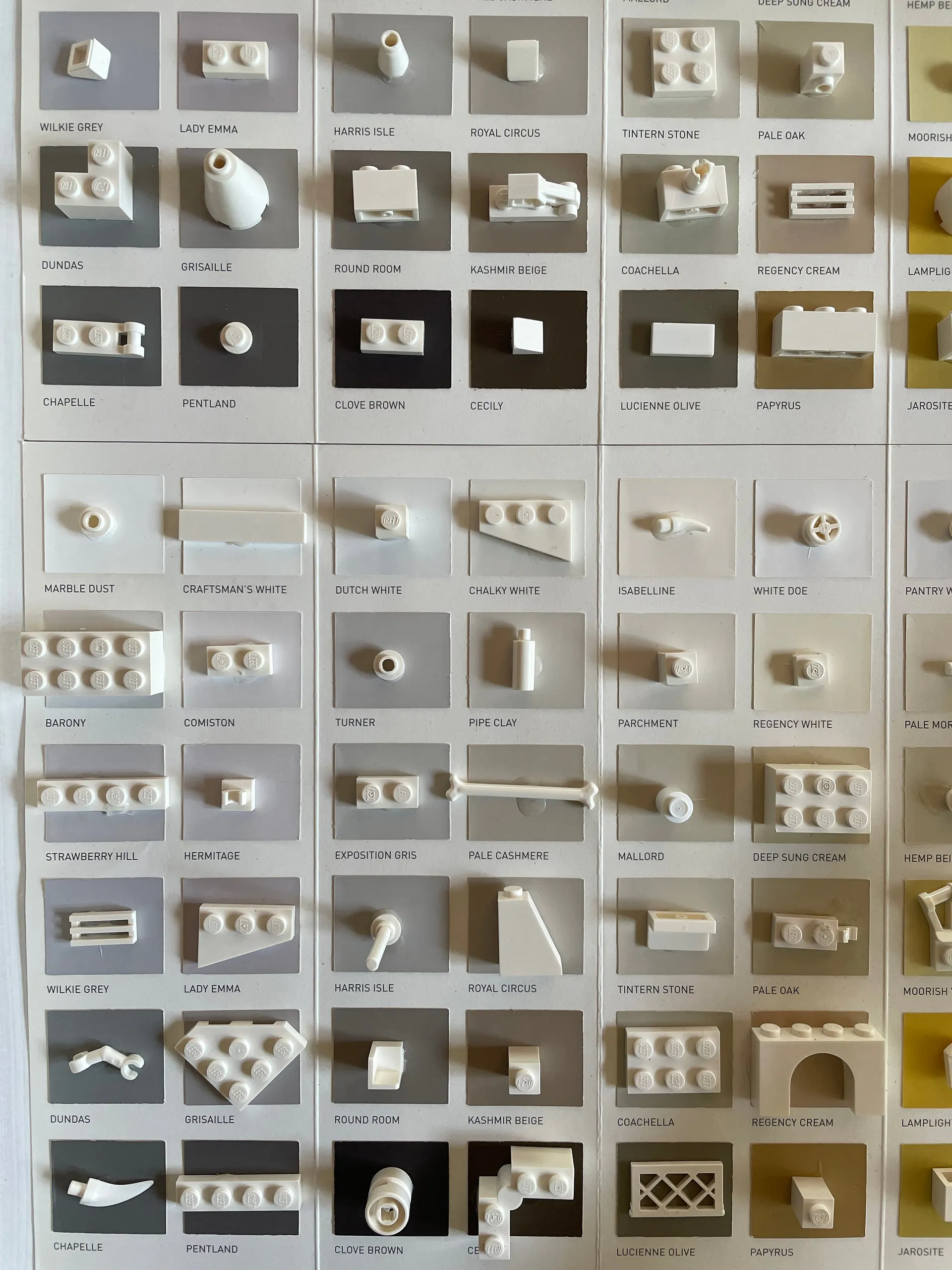 White LEGO pieces covering a chart of greys and neutrals