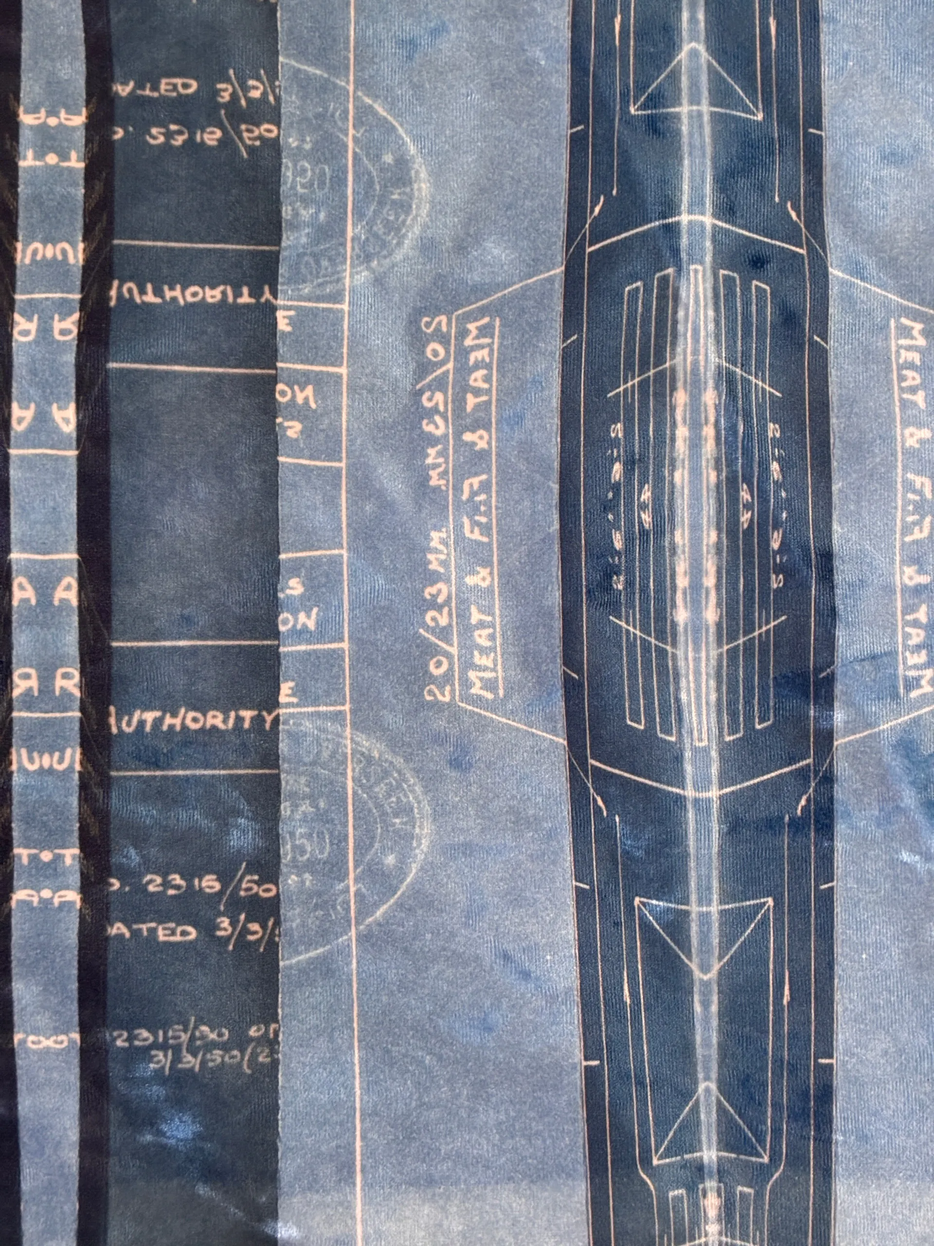 Blueprint annotations and official stamps printed onto cloth