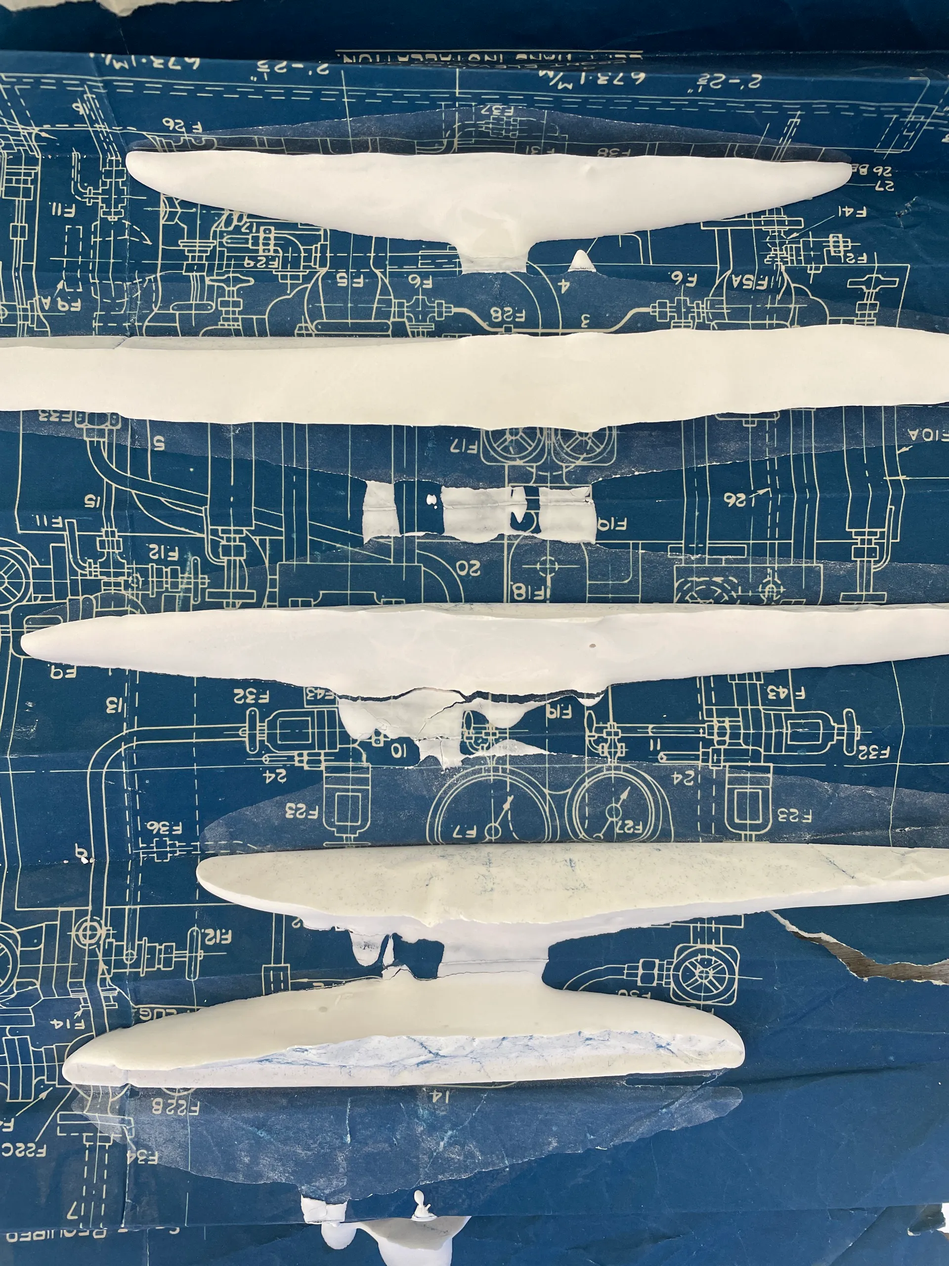 Plaster forms laid across a 1940s blueprint
