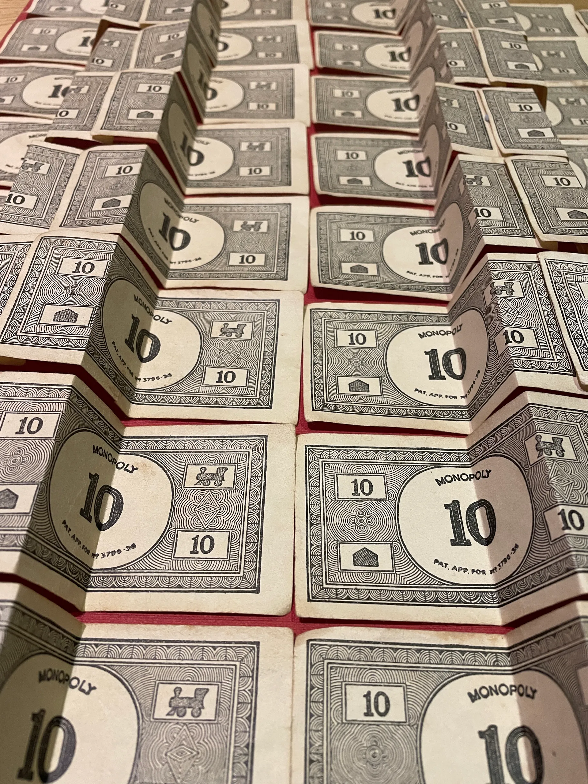 Vintage Monopoly ten-pound notes folded into rows