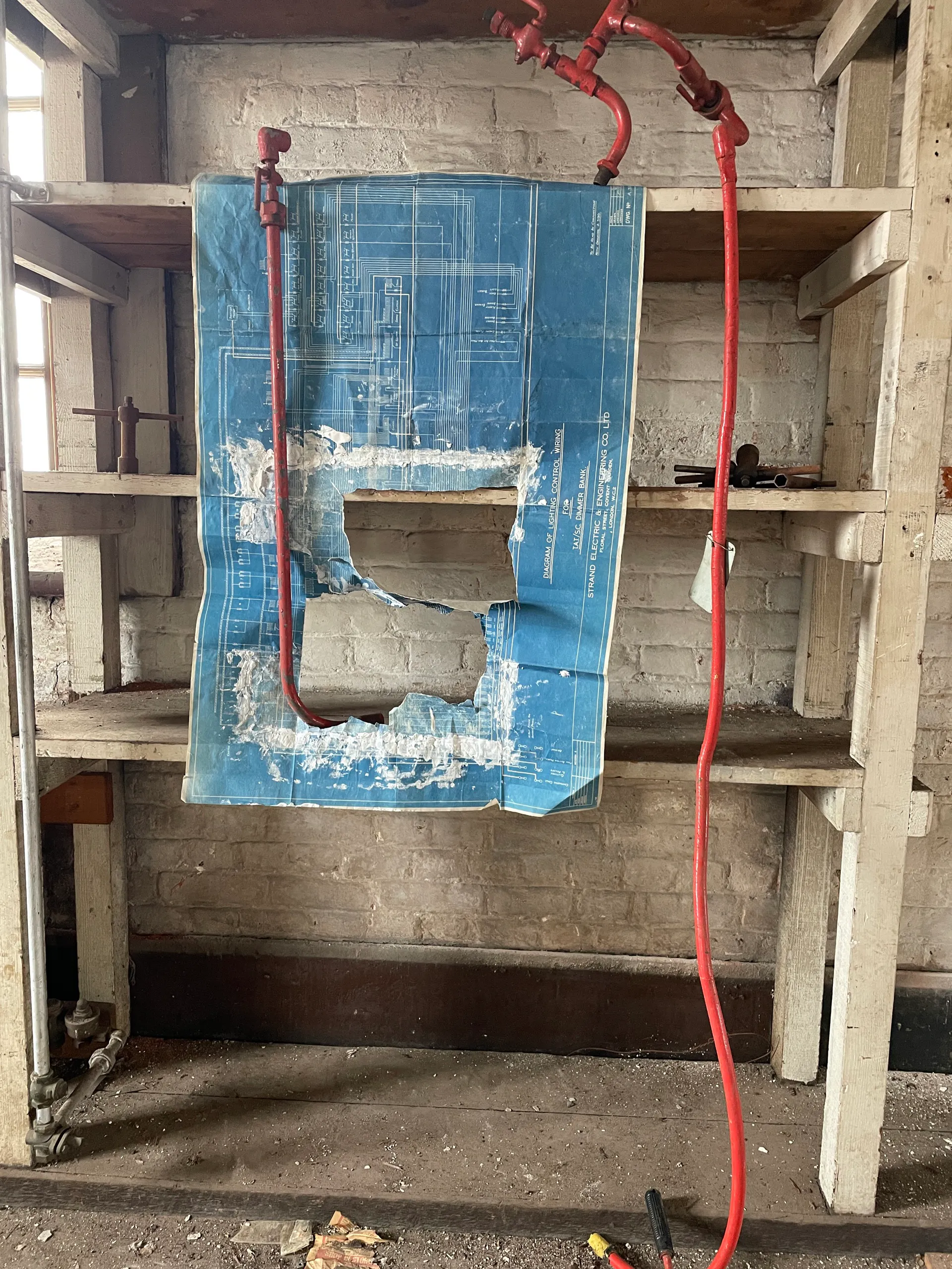 A blueprint-and-plaster work draped over a workbench