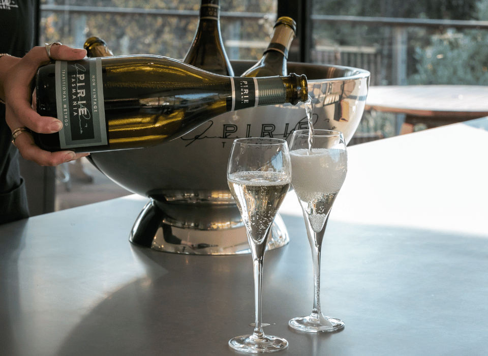 A glass of sparkling wine being poured