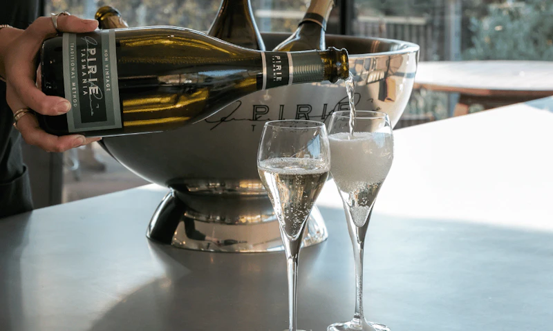 A glass of sparkling wine being poured