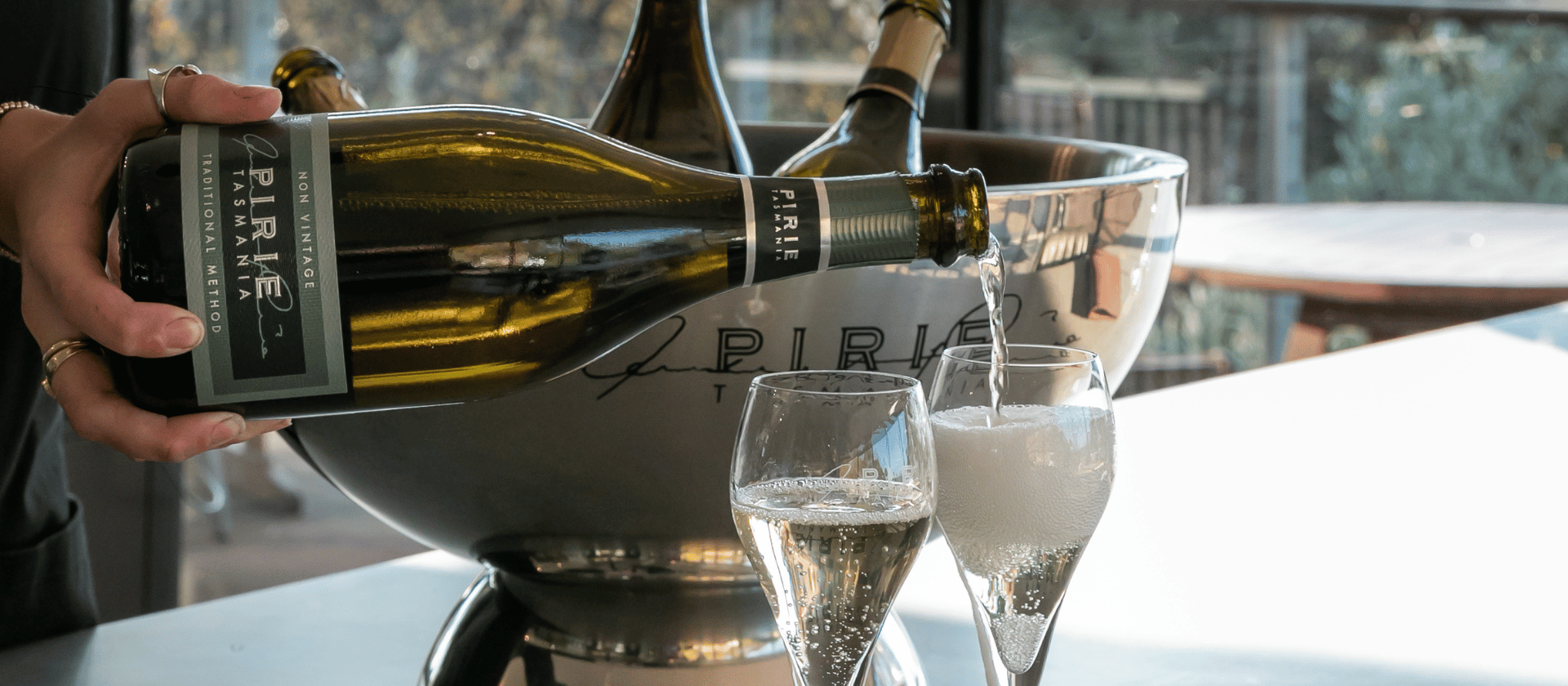 A glass of sparkling wine being poured