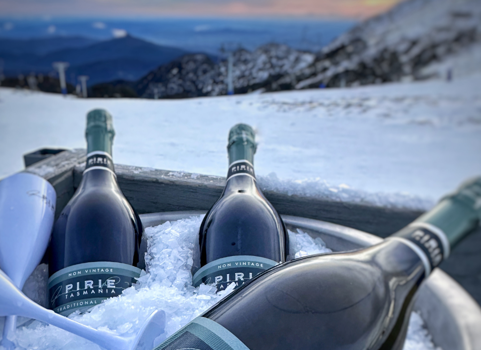 Bottles of Pirie in an ice bucket with the mountains in the background