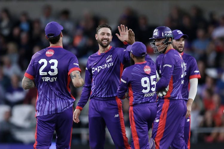 cricket team high five eachother