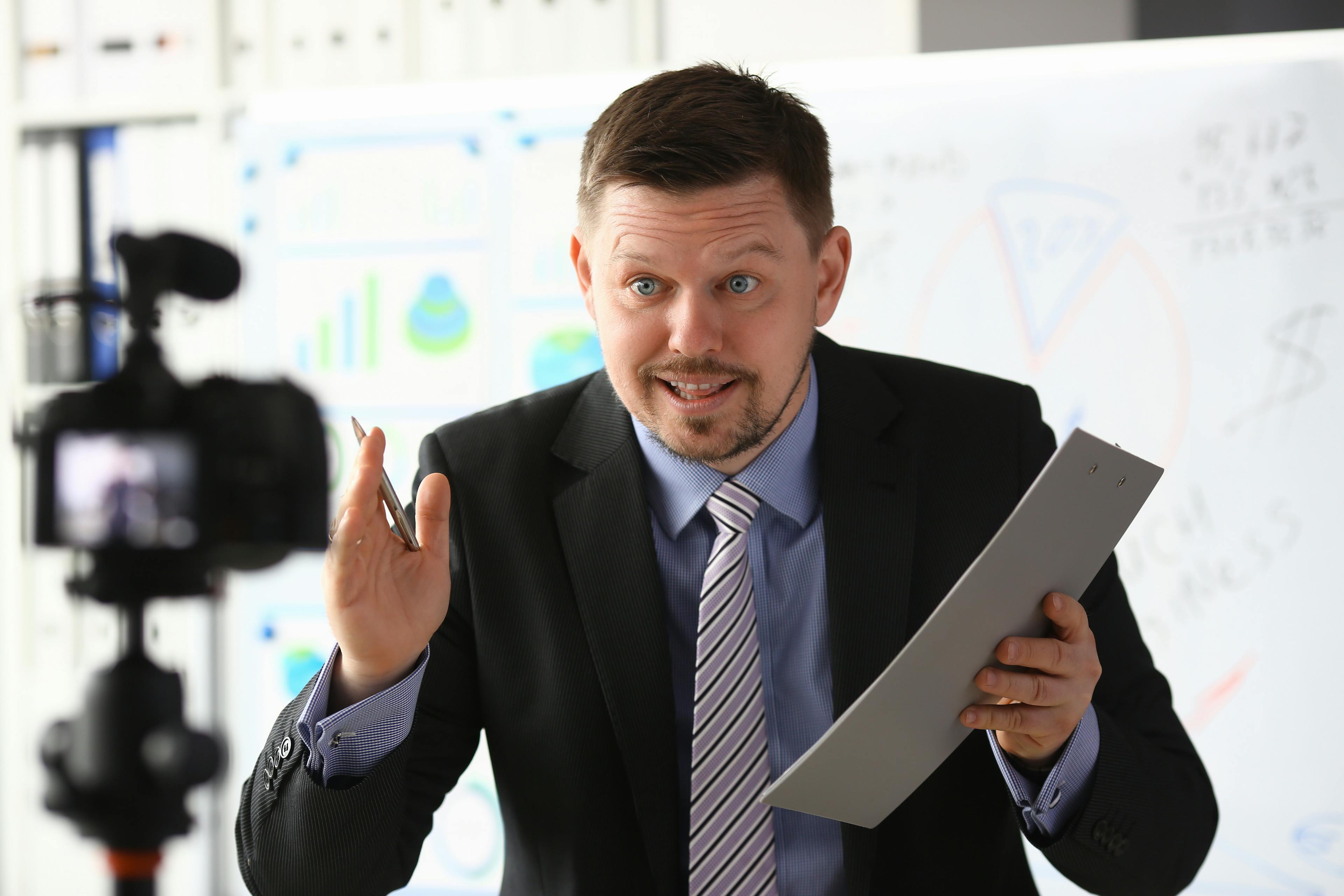 businessman being filmed by a camera