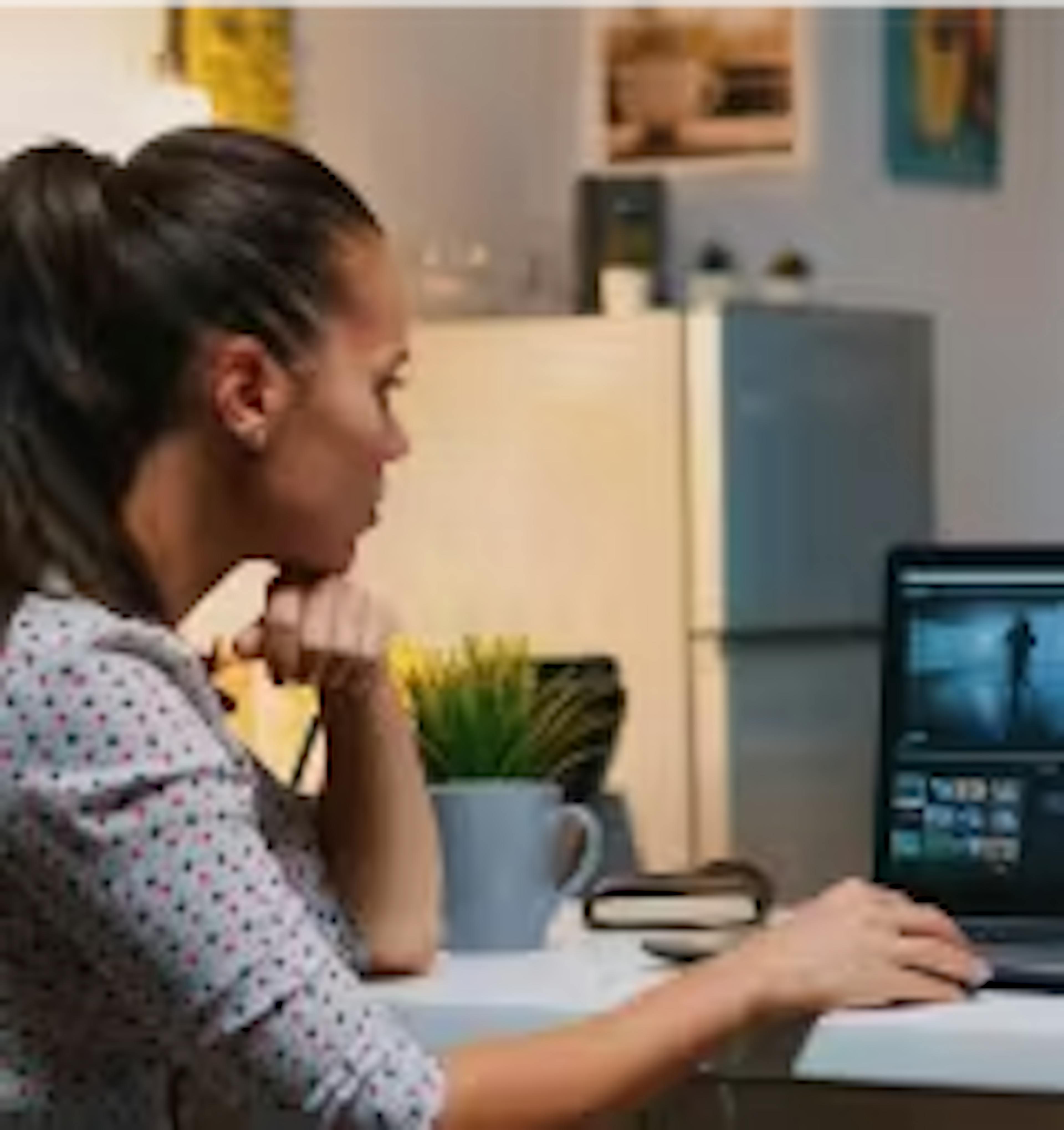 woman watching a replay on a laptop