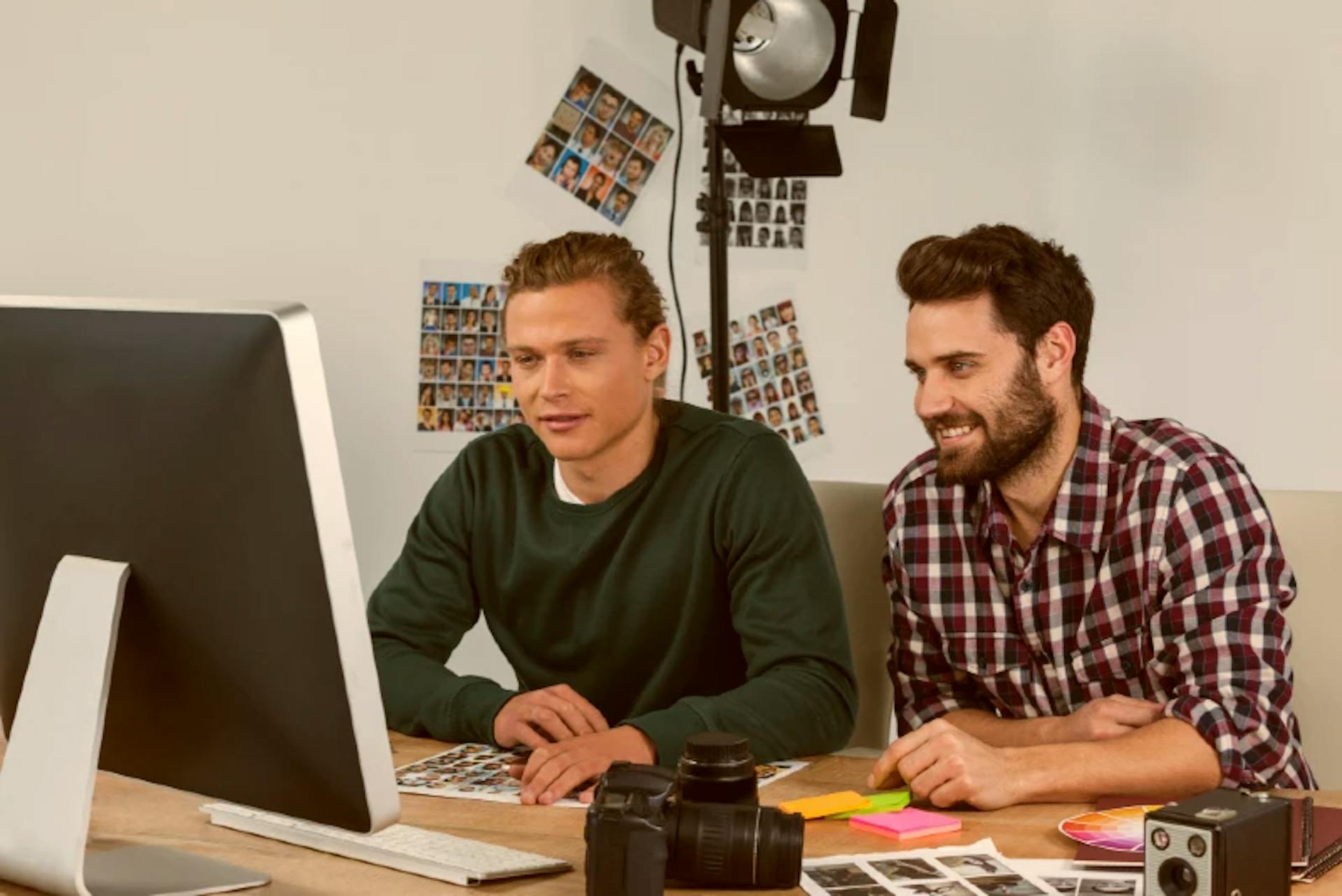 two men in front of a computer with video templates