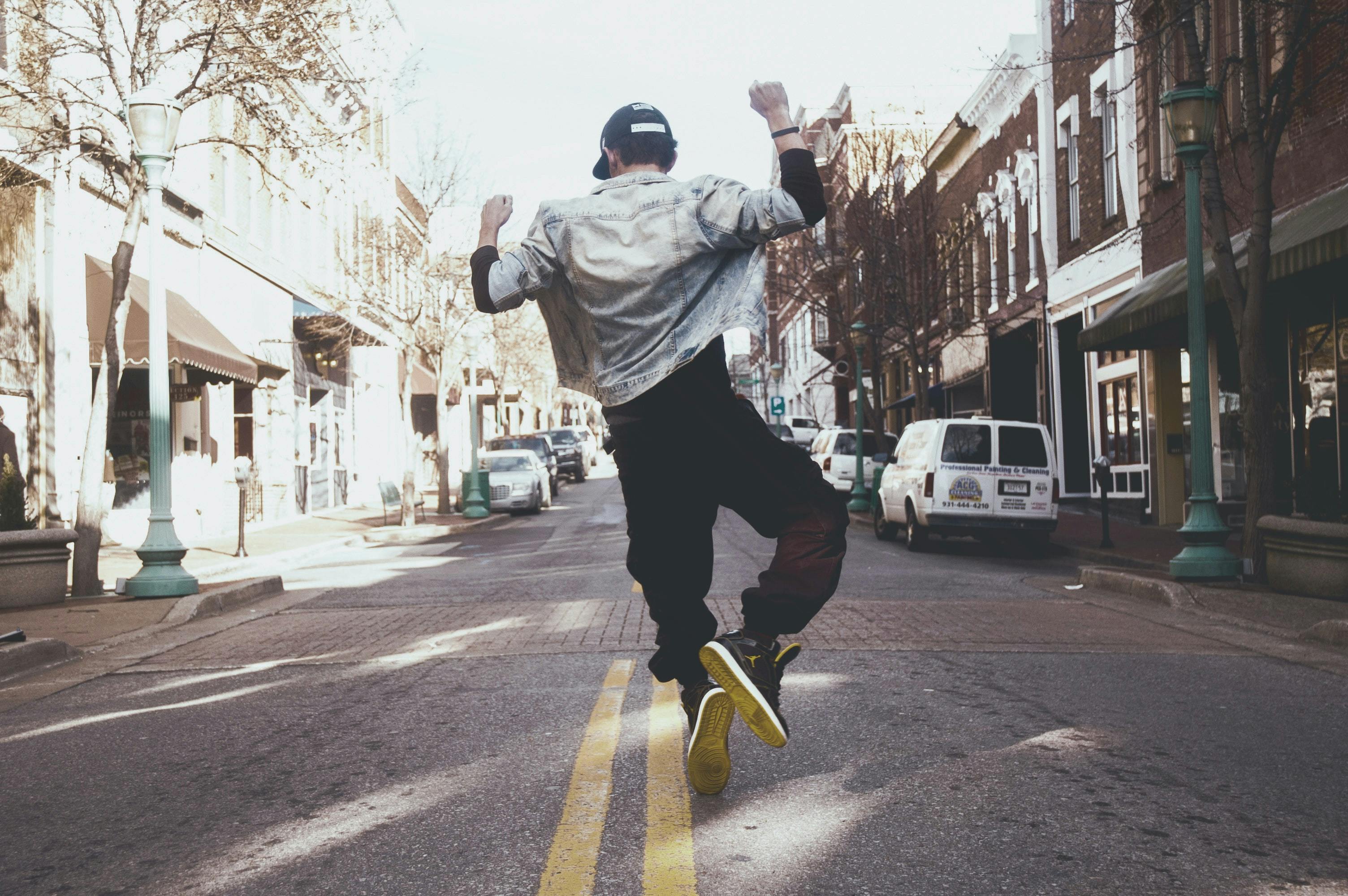 Man jumping for joy in the street. 