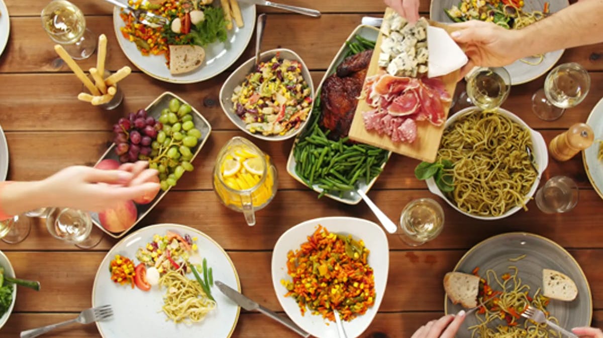 Image of dinner table with plates of food 