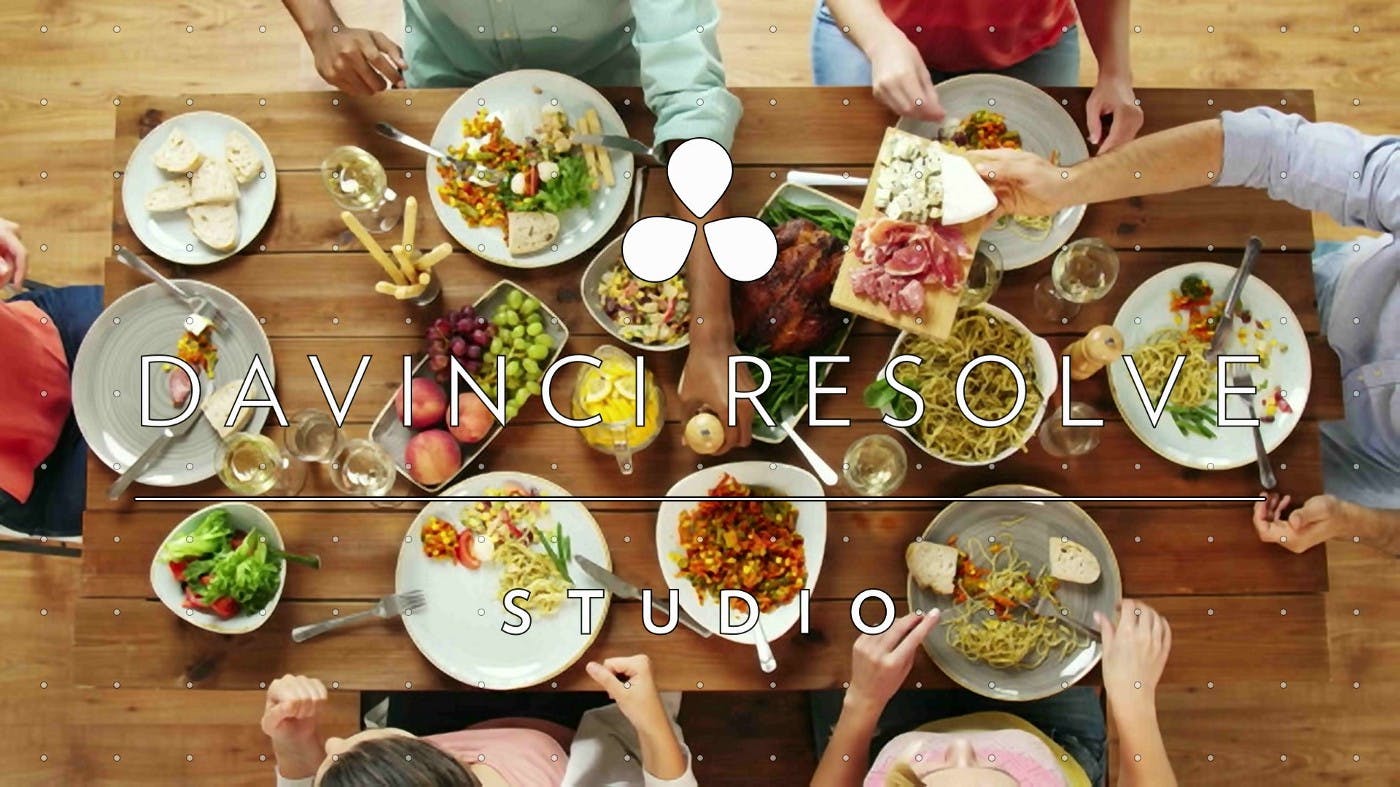 Image of dinner table with  people reaching for array of different dishes. 