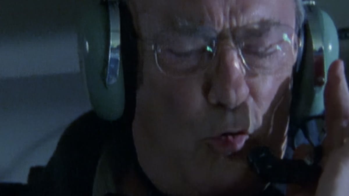 Closeup image of man's face wearing large green headphones 