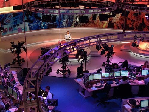 newsroom with anchor and cameras