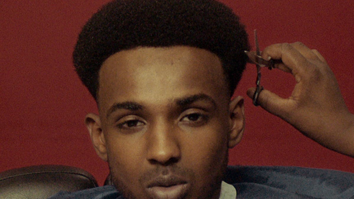 Closeup of young man's face during a haircut