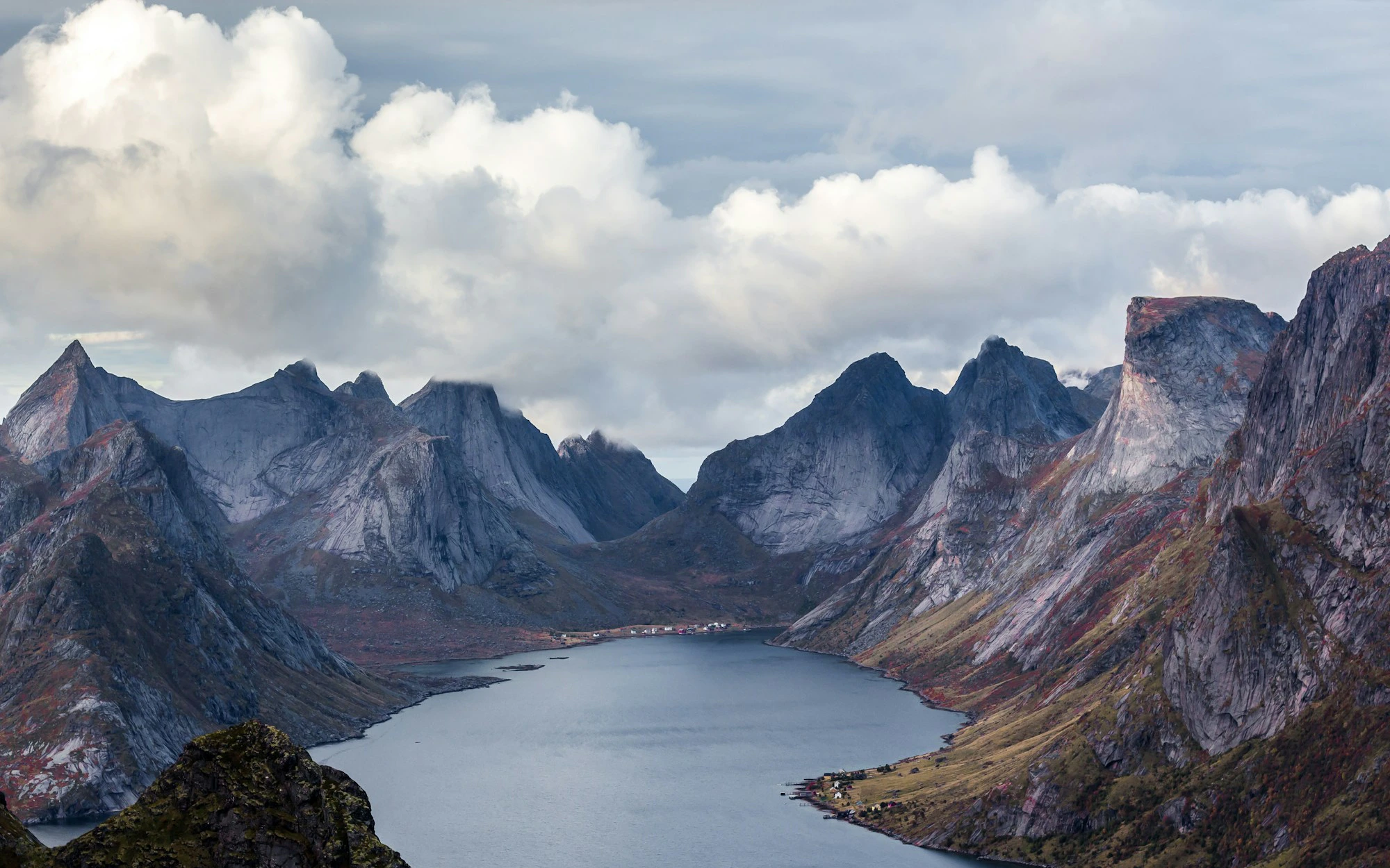 body of water surrounded mountain peak