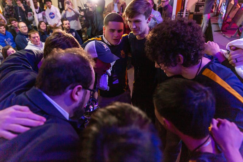 High school esports team huddling together before a match