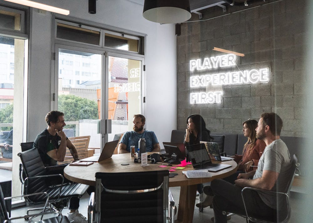 Group of employees sitting around a table having a meeting