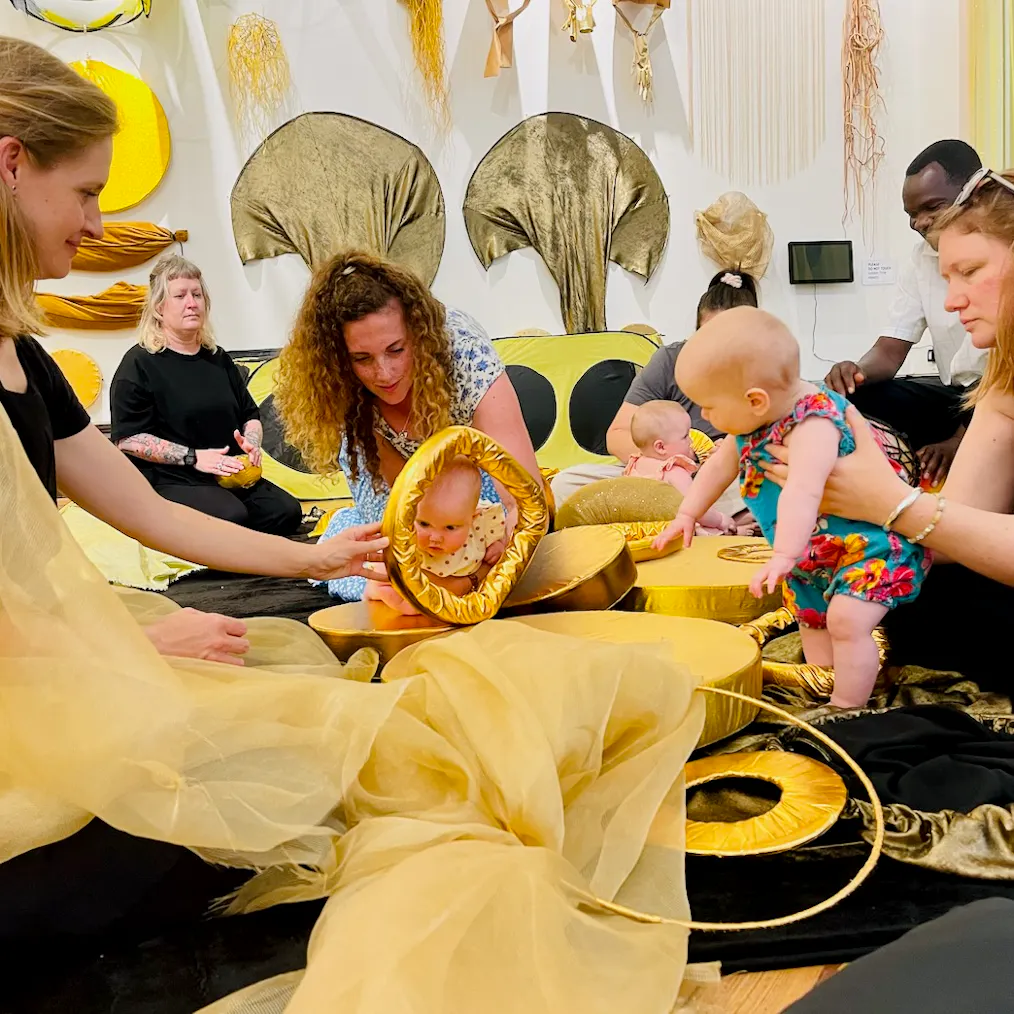 Babies, parents, carers and artists engaging with each other during a session
