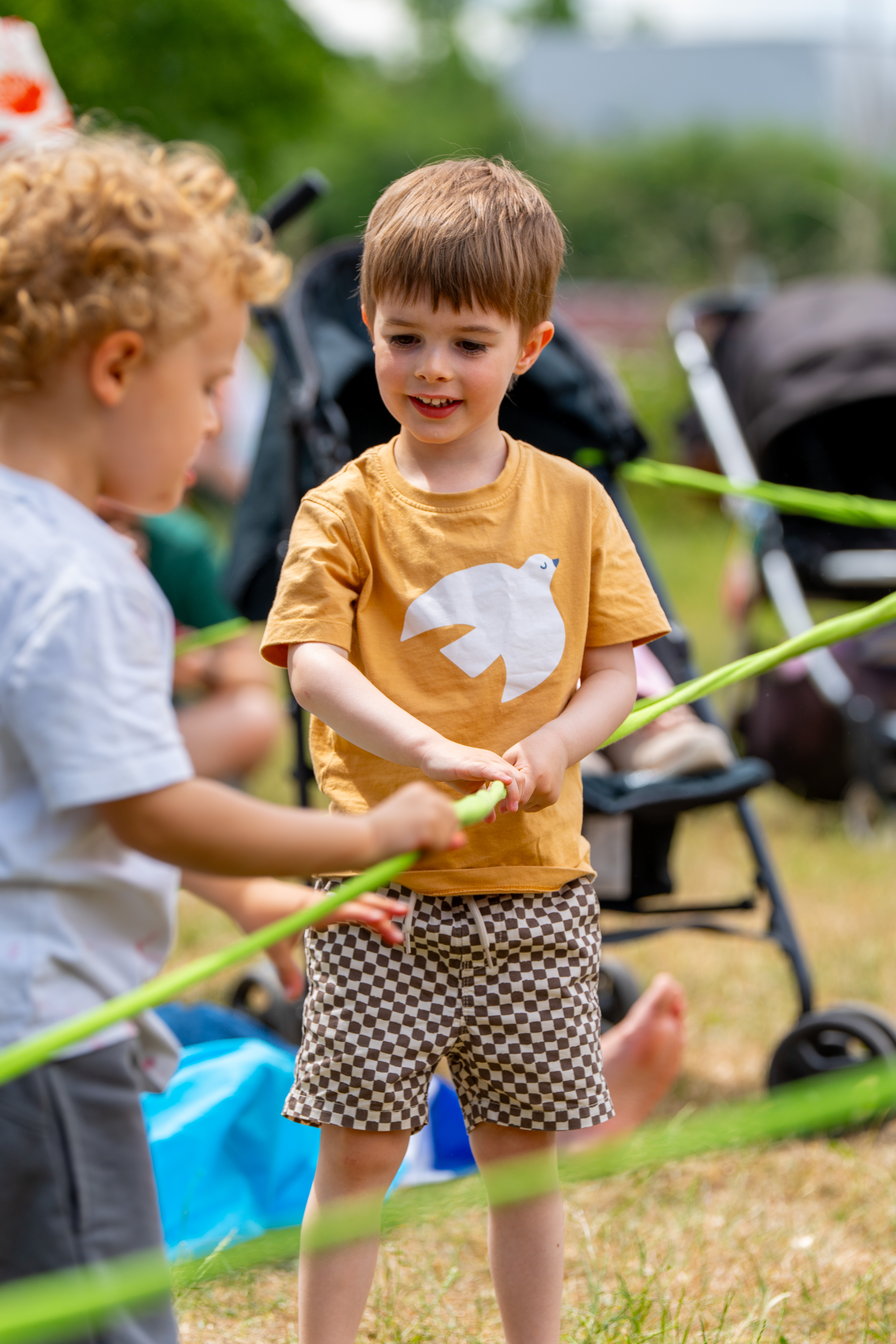 Two children engaging with rope together 