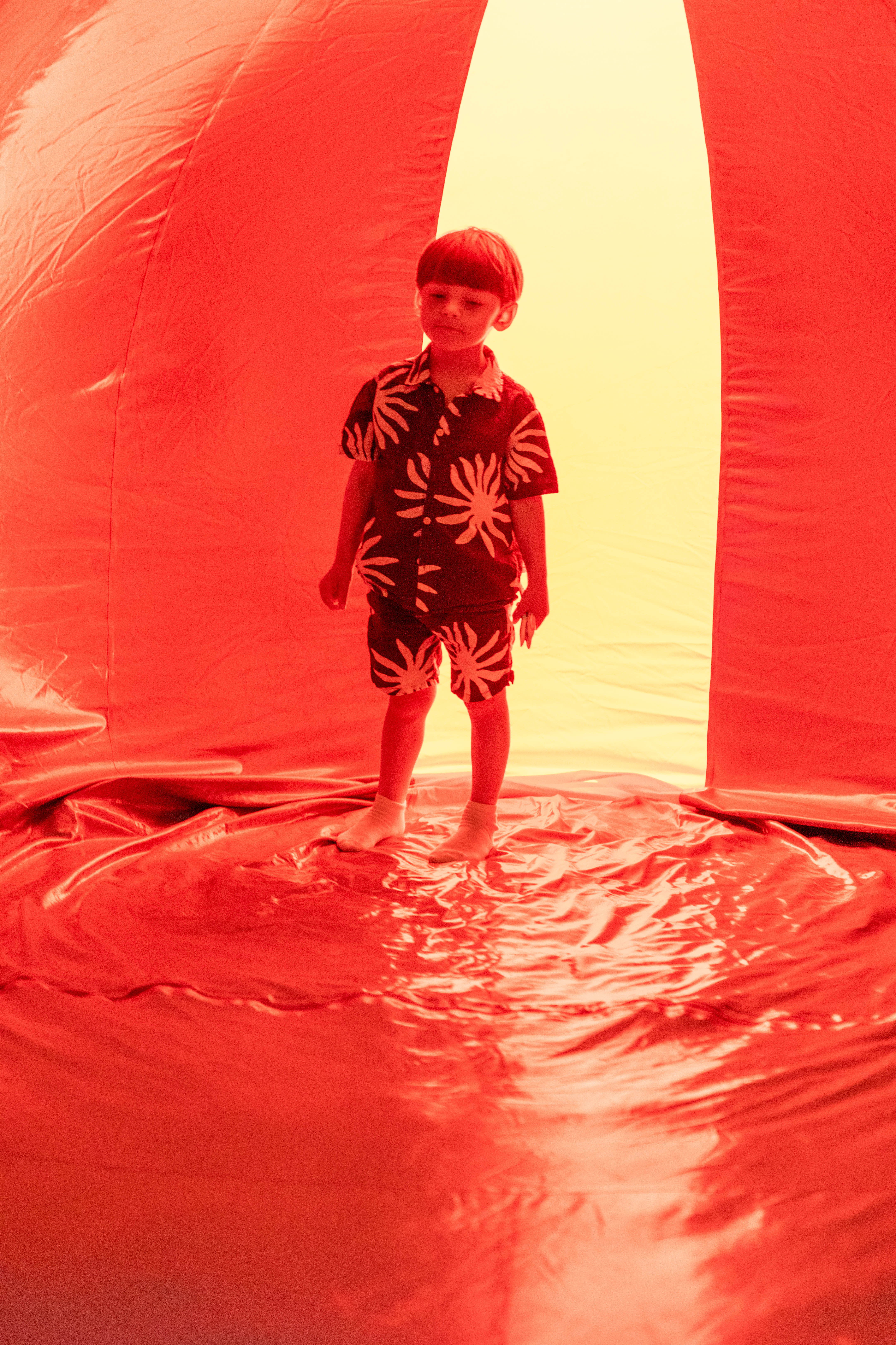 A young child stood in a red lit inflatable 