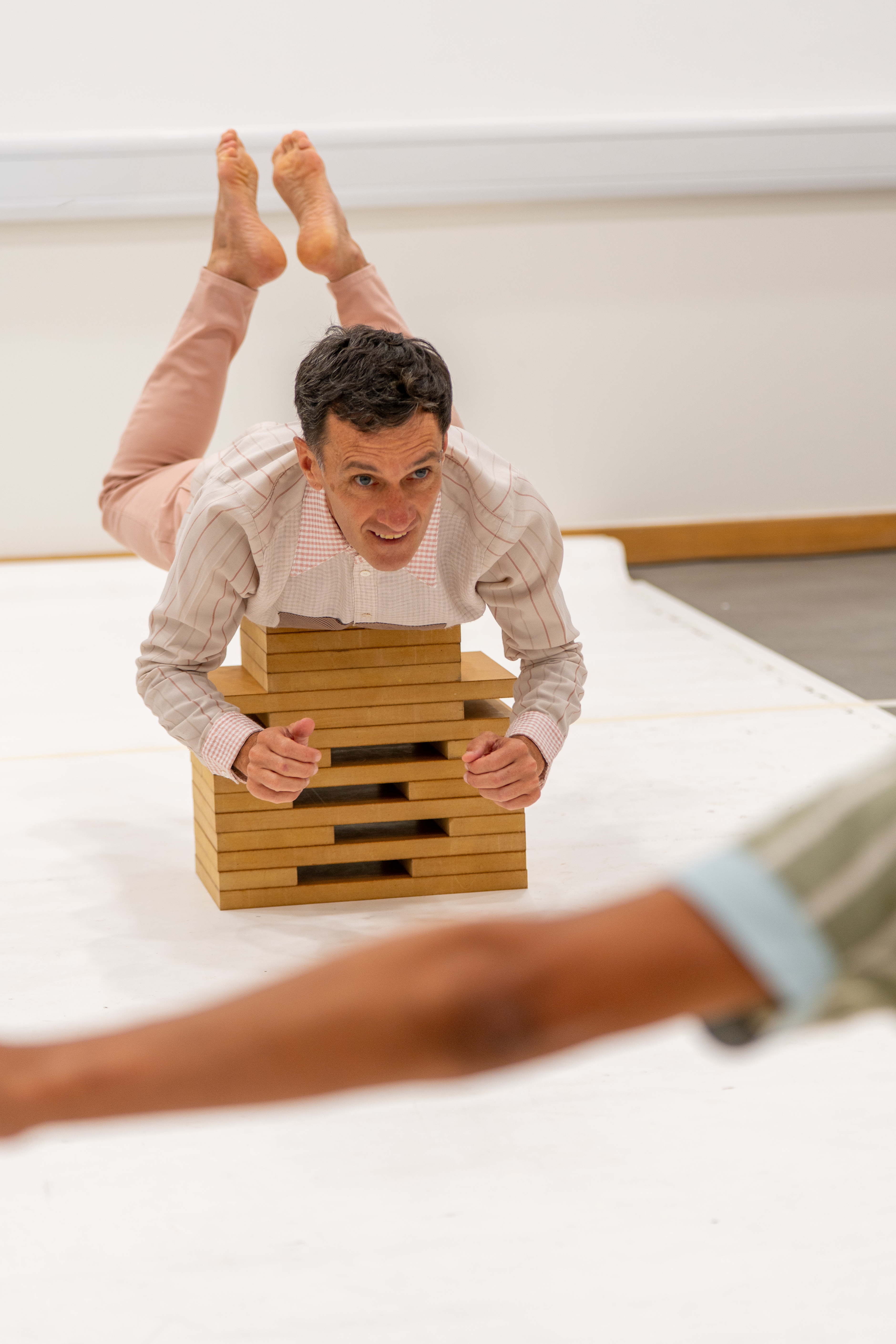 An artist lying on blocks 