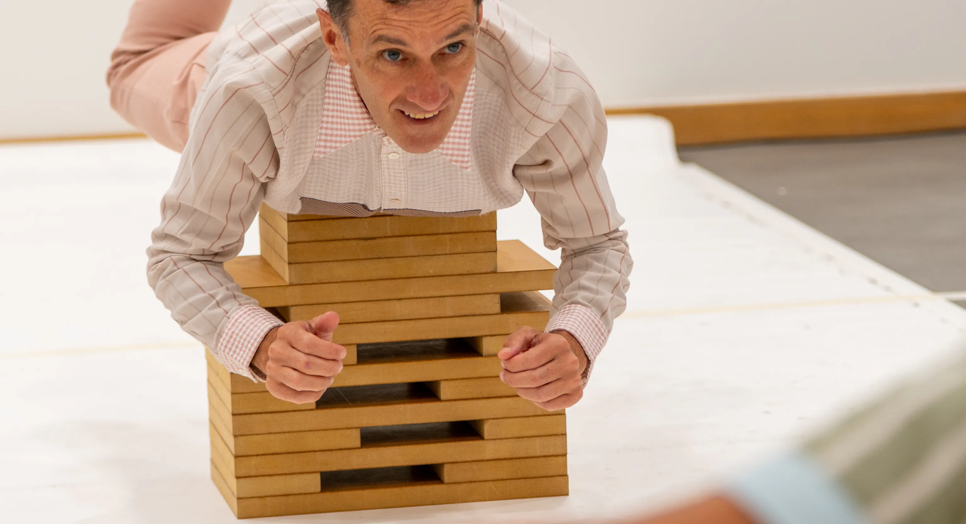 An artist lying on blocks
